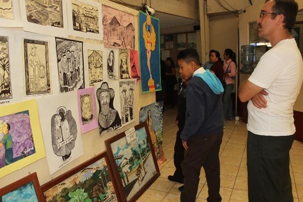 Estudiantes observan  pinturas y dibujos,  en el salón de la municipalidad. (Foto Prensa  Libre: Óscar González)