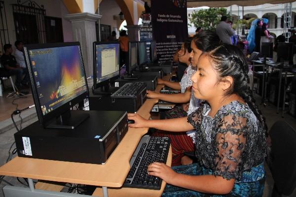 Un grupo de estudiantes usa las computadoras donadas.