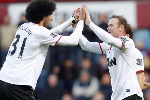 Fellaini felicita a Rooney tras anotar uno de los goles de este sábado. (Foto Prensa Libre: EFE)