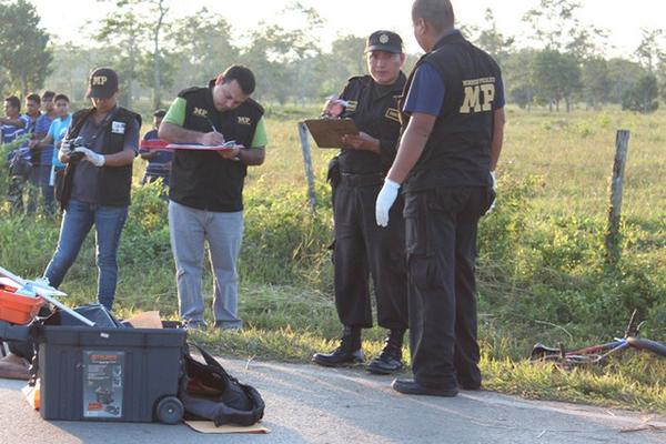 Uno de los cuerpos quedó en la carretera, fiscales del MP recolectan evidencias. (Foto Prensa Libre: Rigoberto Escobar)<br _mce_bogus="1"/>