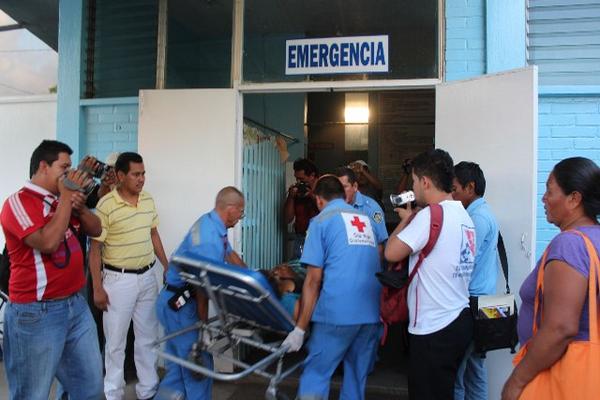 Socorristas trasladan a una madre y su hijo que fueron atacados, en un sector de Coatepeque, Quetzaltenango. (Foto Prensa Libre: Alexander Coyoy)<br _mce_bogus="1"/>