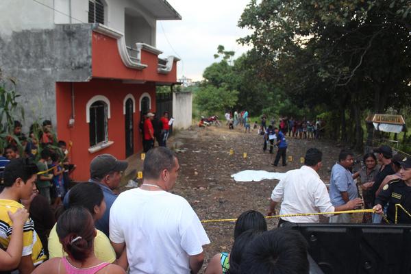 Vecinos del lugar observan la escena del crimen donde fiscales del MP recogen evidencias del ataque (Foto Prensa Libre: Alexander Coyoy)<br _mce_bogus="1"/>