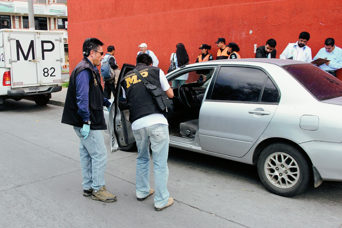 Investigadores inspeccionan vehículo que fue objeto de robo, en Quetzaltenango. (Foto Prensa Libre: Carlos Ventura)