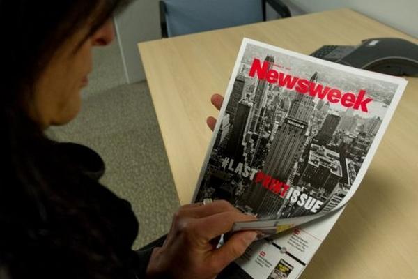 Una mujer lee el último número impreso de la revista estadounidense Newsweek. (Foto Prensa Libre: AFP)