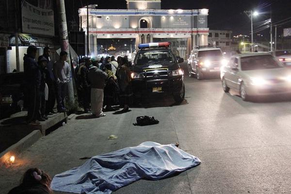 Bomberos, policías y curiosos en el lugar donde se estrelló el motorista. (Foto Prensa Libre: Carlos Ventura)<br _mce_bogus="1"/>