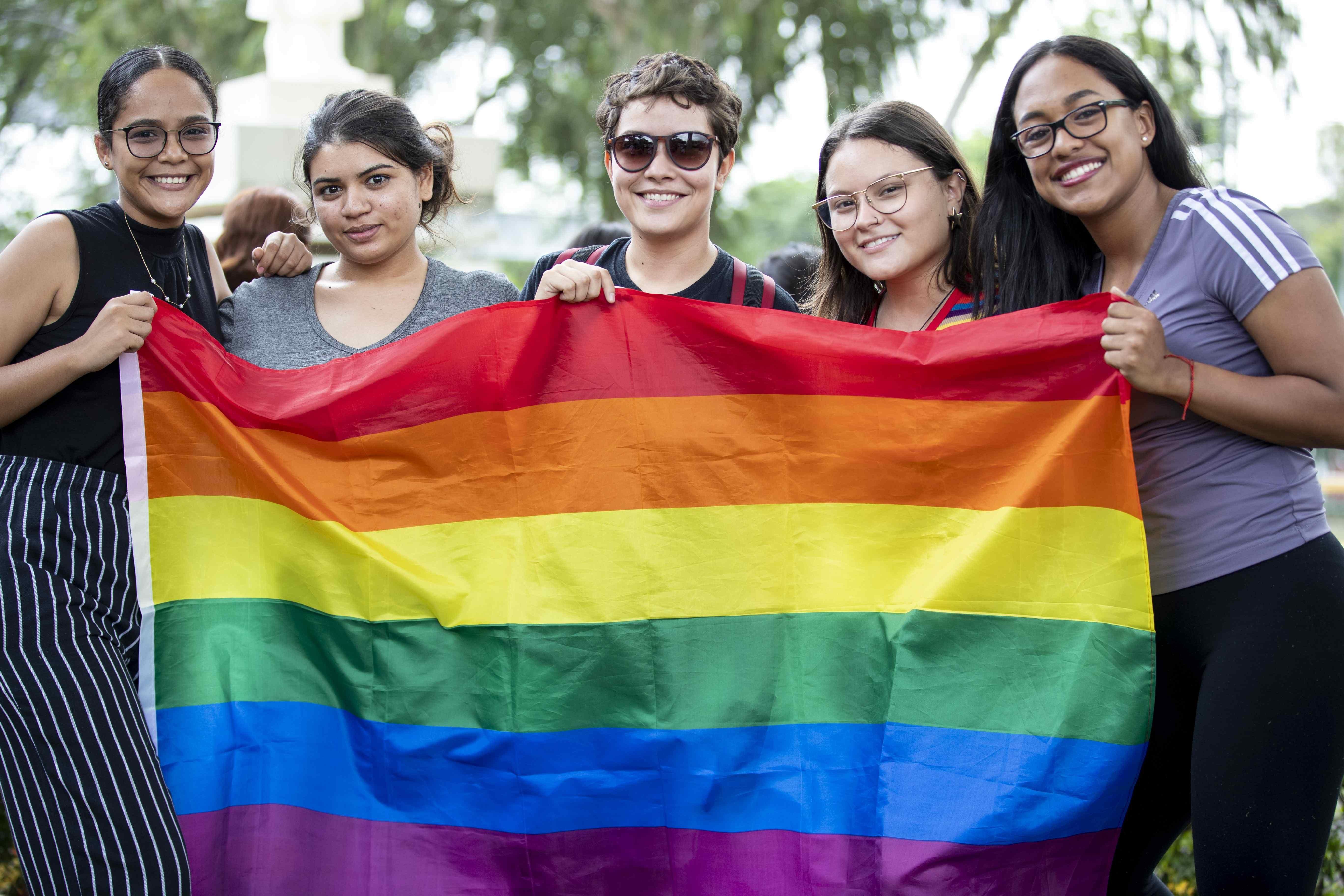 AME2645. MANAGUA (NICARAGUA), 01/07/2019.- Varios jóvenes sostienen una bandera arcoíris durante la marcha del Orgullo LGBT este lunes, en la Universidad Centroamericana (UCA), en Managua (Nicaragua). Miembros de la diversidad sexual nicaragüense celebraron este lunes la marcha del Orgullo LGBT (de lesbianas, gais, bisexuales y transgéneros) gritando consignas en contra del Gobierno que preside el sandinista Daniel Ortega, a quien señalan de no respetar los derechos ciudadanos. EFE/ Jorge Torres