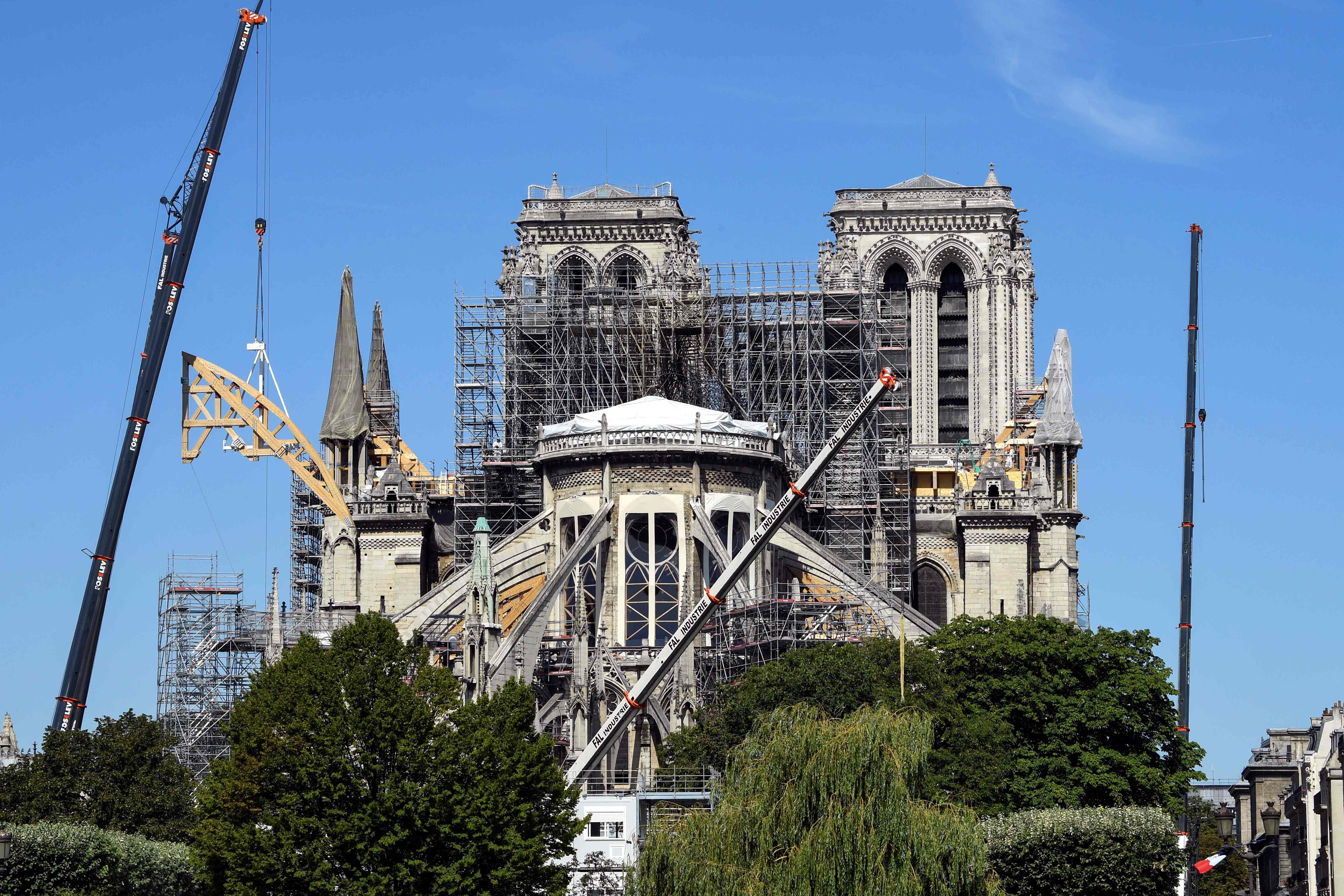 (FILES) In this file photo taken on July 9, 2019 in Paris, shows Notre-Dame de Paris cathedral as reconstruction works are ongoing after it was badly damaged by a huge fire last April 15. - The gigantic and complex site launched after the fire that ravaged the roof of Notre-Dame de Paris cathedral, interrupted last July 25 because of the risk of lead contamination, will restart on August 19. The labour inspectorate halted the construction site on July 25 to strengthen the protection of the workers. Decontamination of the grounds around the cathedral and several schools has since been launched. (Photo by BERTRAND GUAY / AFP)