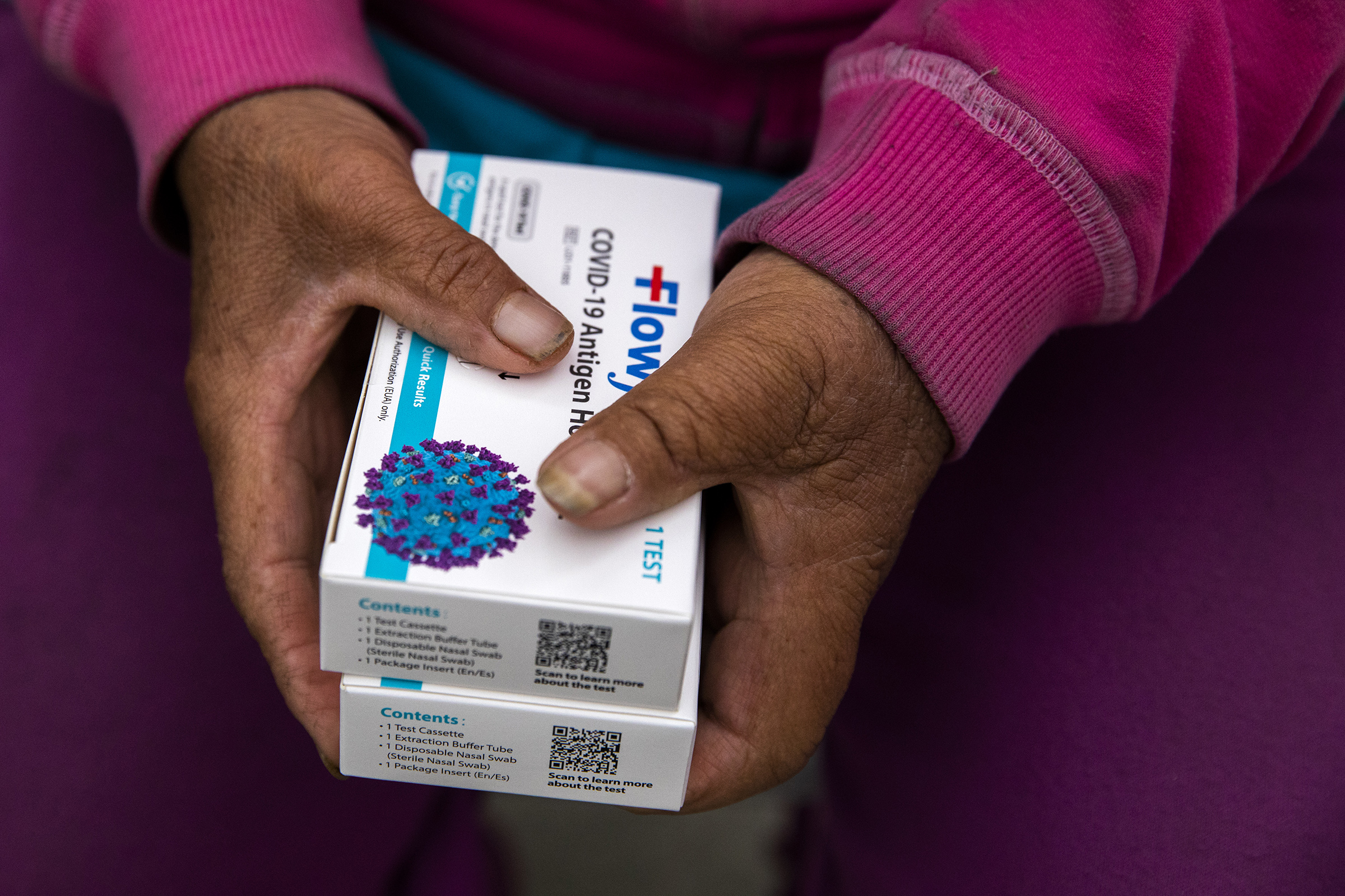 Mujer sostiene cajas de pruebas de antígeno para detectar coronavirus. (Foto Prensa Libre: Alisha Jucevic / The New York Times)