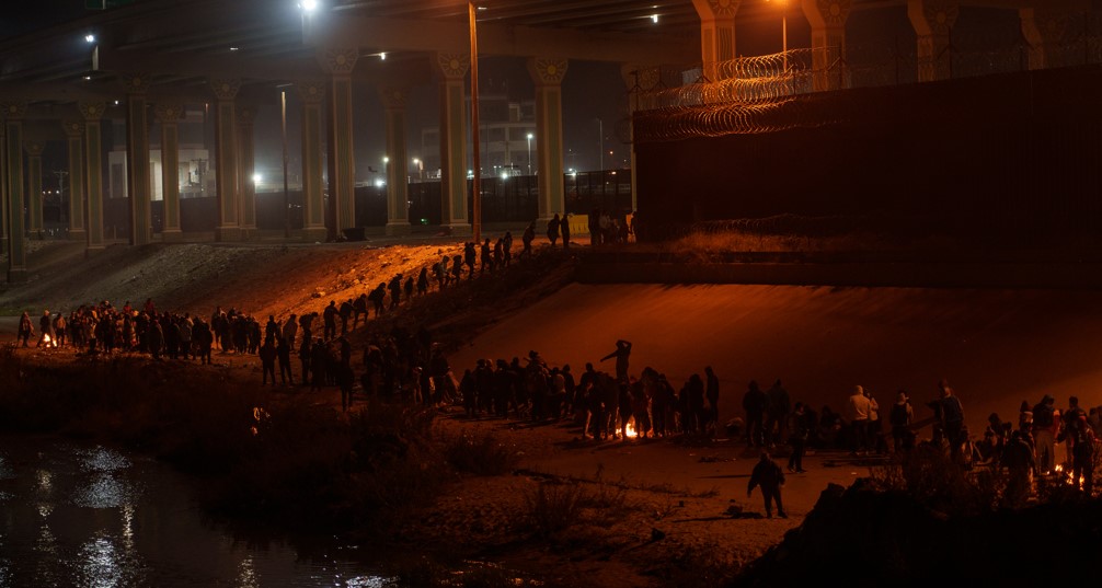 Migrantes tratan de calentarse en la frontera entre EE. UU. y México. (Foto Prensa Libre: Paul Ratje/The New York Times).