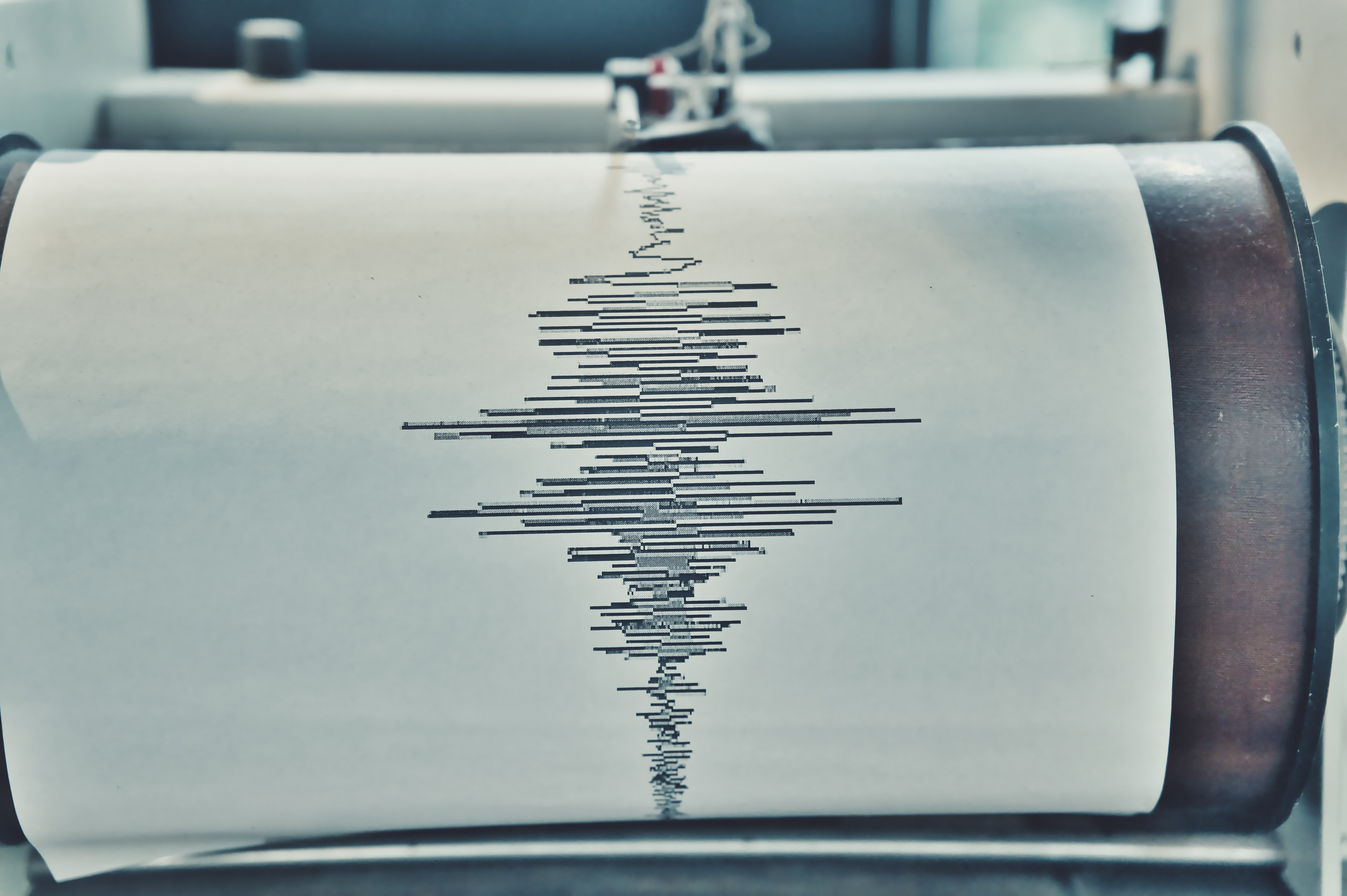 Documenting Earth's Movement: A Sismograph Recording Device with Seismic Waves Traced on Paper