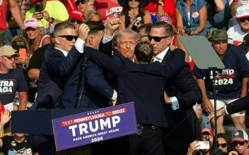 Republican candidate Donald Trump is seen with blood on his face surrounded by secret service agents as he is taken off the stage at a campaign event at Butler Farm Show Inc. in Butler, Pennsylvania, July 13, 2024. Republican candidate Donald Trump was evacuated from the stage at today's rally after what sounded like shots rang out at the event in Pennsylvania, according to AFP.
The former US president was seen with blood on his right ear as he was surrounded by security agents, who hustled him off the stage as he pumped his first to the crowd.
Trump was bundled into an SUV and driven away. (Photo by Rebecca DROKE / AFP)