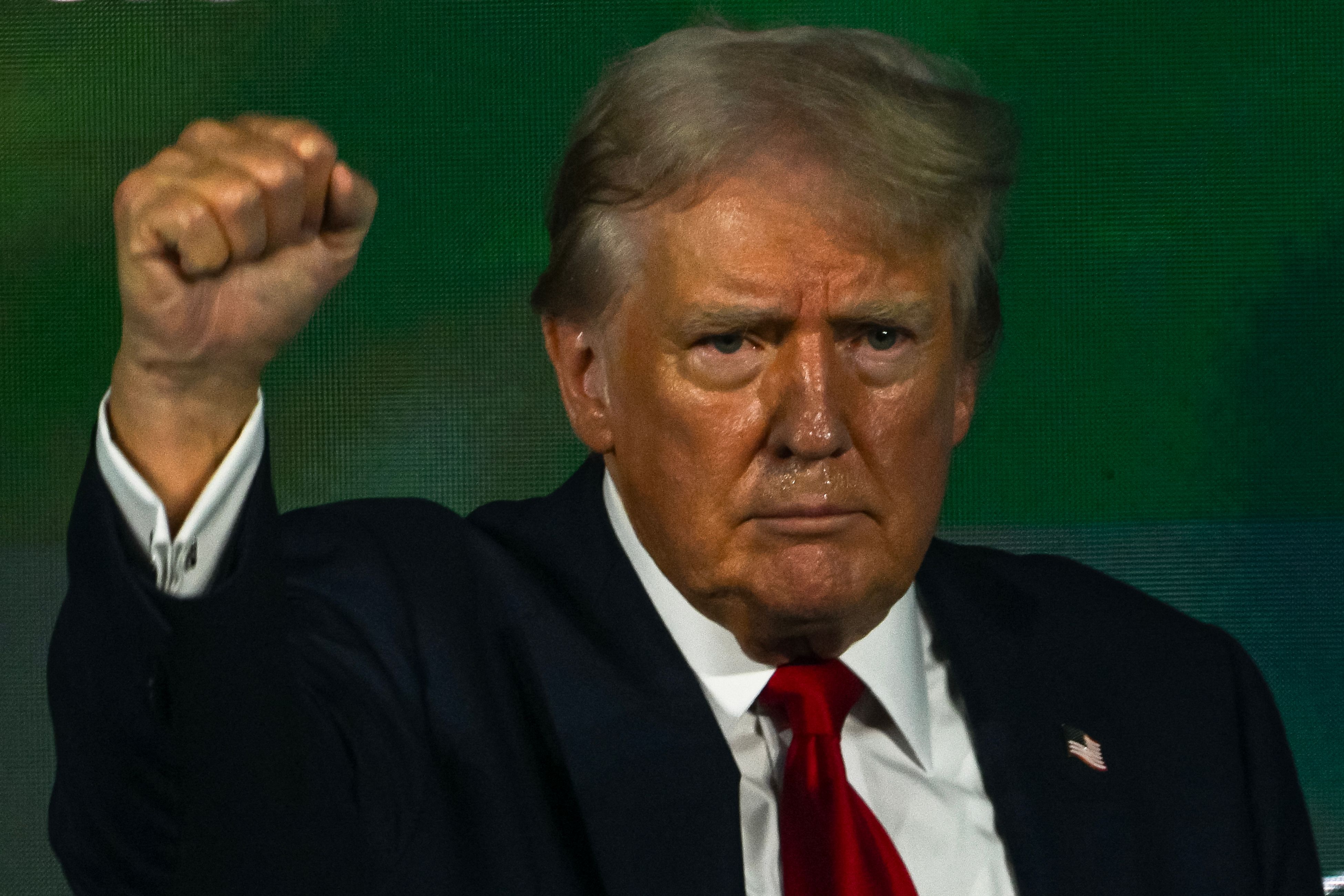 Former US President and 2024 Republican presidential candidate Donald Trump gestures after speaking at Turning Point Action's "The Believers Summit" in West Palm Beach, Florida, on July 26, 2024. (Photo by CHANDAN KHANNA / AFP)