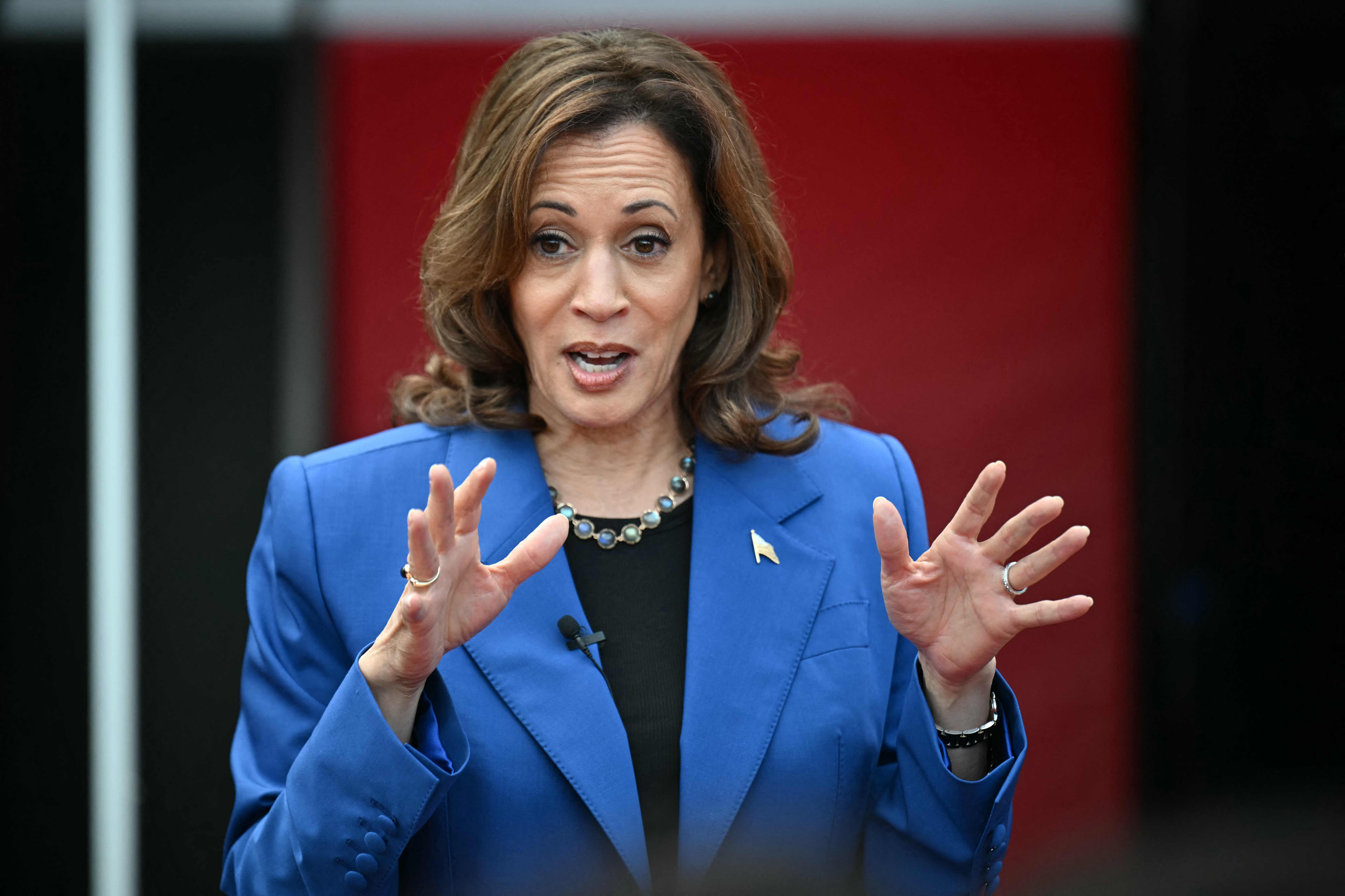 US Vice President and Democratic presidential candidate Kamala Harris speaks to the football team at Aliquippa High School during a stop on her campaign bus tour in Aliquippa, Pennsylvania, on August 18, 2024. Harris embarked on a bus tour of the potentially election-deciding state of Pennsylvania on Sunday, as she keeps up the momentum before her star turn at the Democratic National Convention in Chicago. (Photo by ANGELA WEISS / AFP)