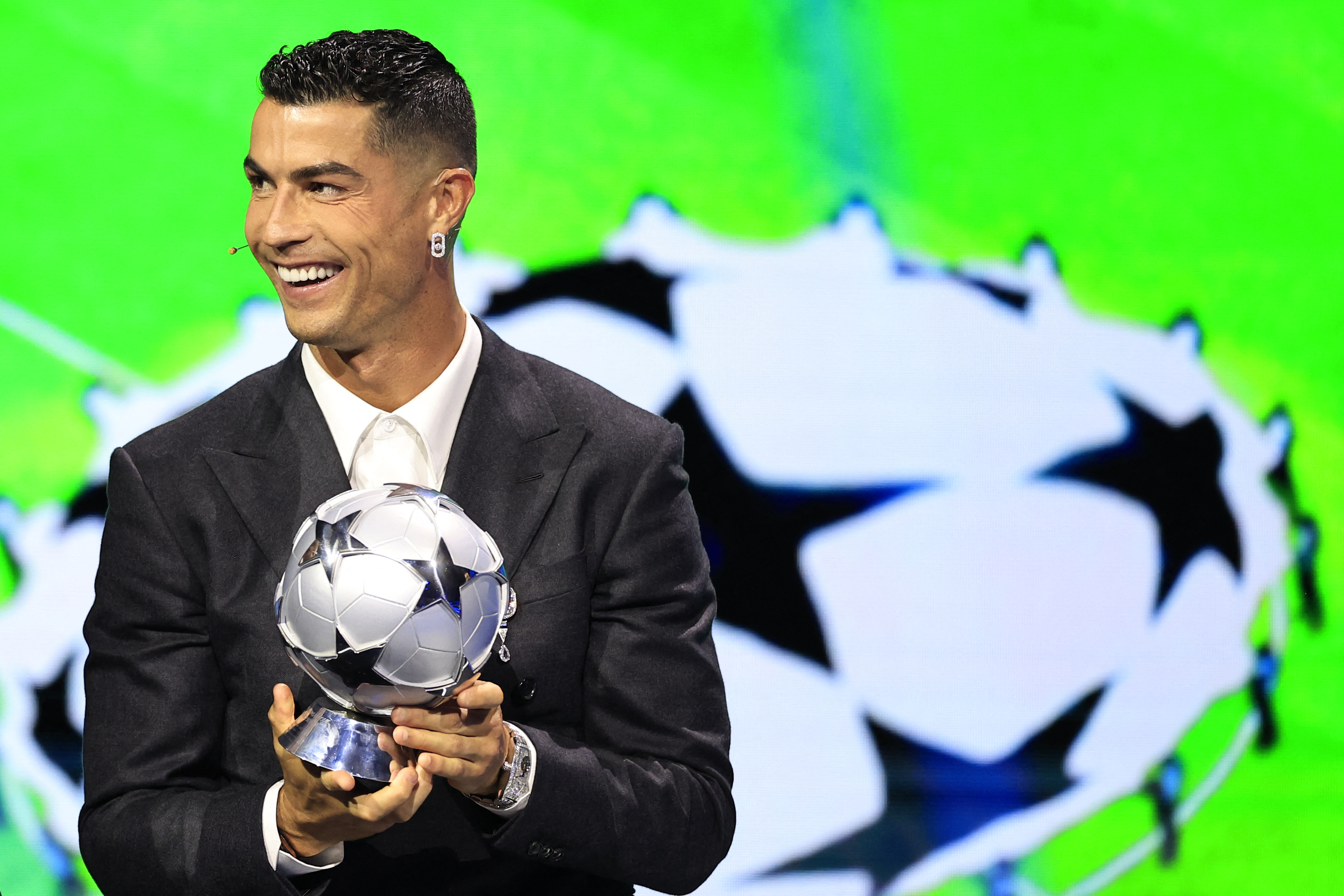 Portugal's national team player and Saudi Al-Nassr's forward Cristiano Ronaldo receives the All-Time Goalscorer Award in the UEFA Champions League during the ceremony of the draw for the group stage of the 2024-2025 UEFA Champions League football tournament, at the Grimaldi Forum in Monaco on August 29, 2024. (Photo by Valery HACHE / AFP)