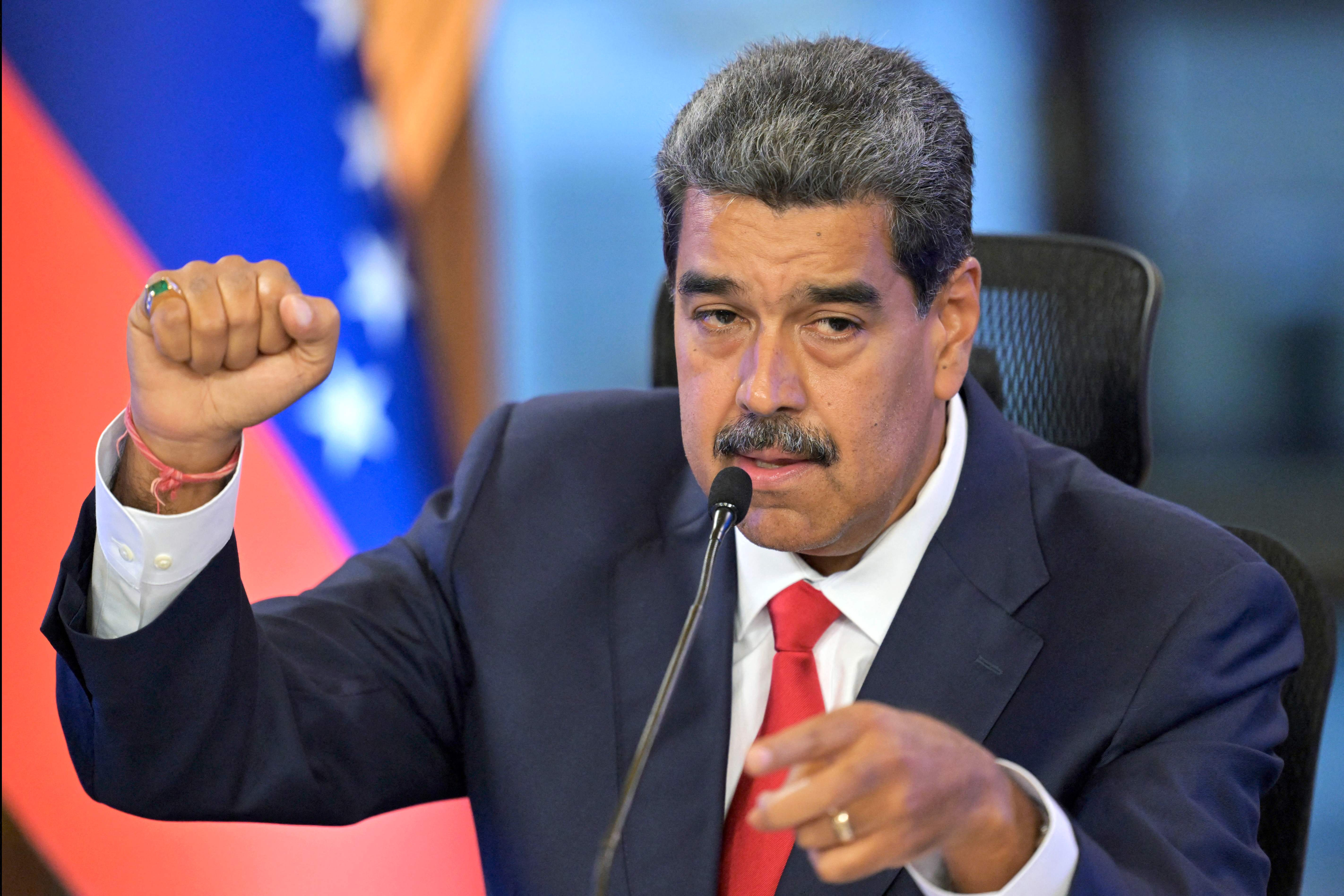 Venezuelan President Nicolas Maduro gestures during a press conference about the presidential election at the Miraflores presidential palace in Caracas on August 2, 2024. The ruling TSJ summoned candidates of last presidential election, accused by the opposition of being fraudulent, after accepting an appeal by the proclaimed winner Nicolas Maduro for the highest court to certify the process. (Photo by Juan BARRETO / AFP)