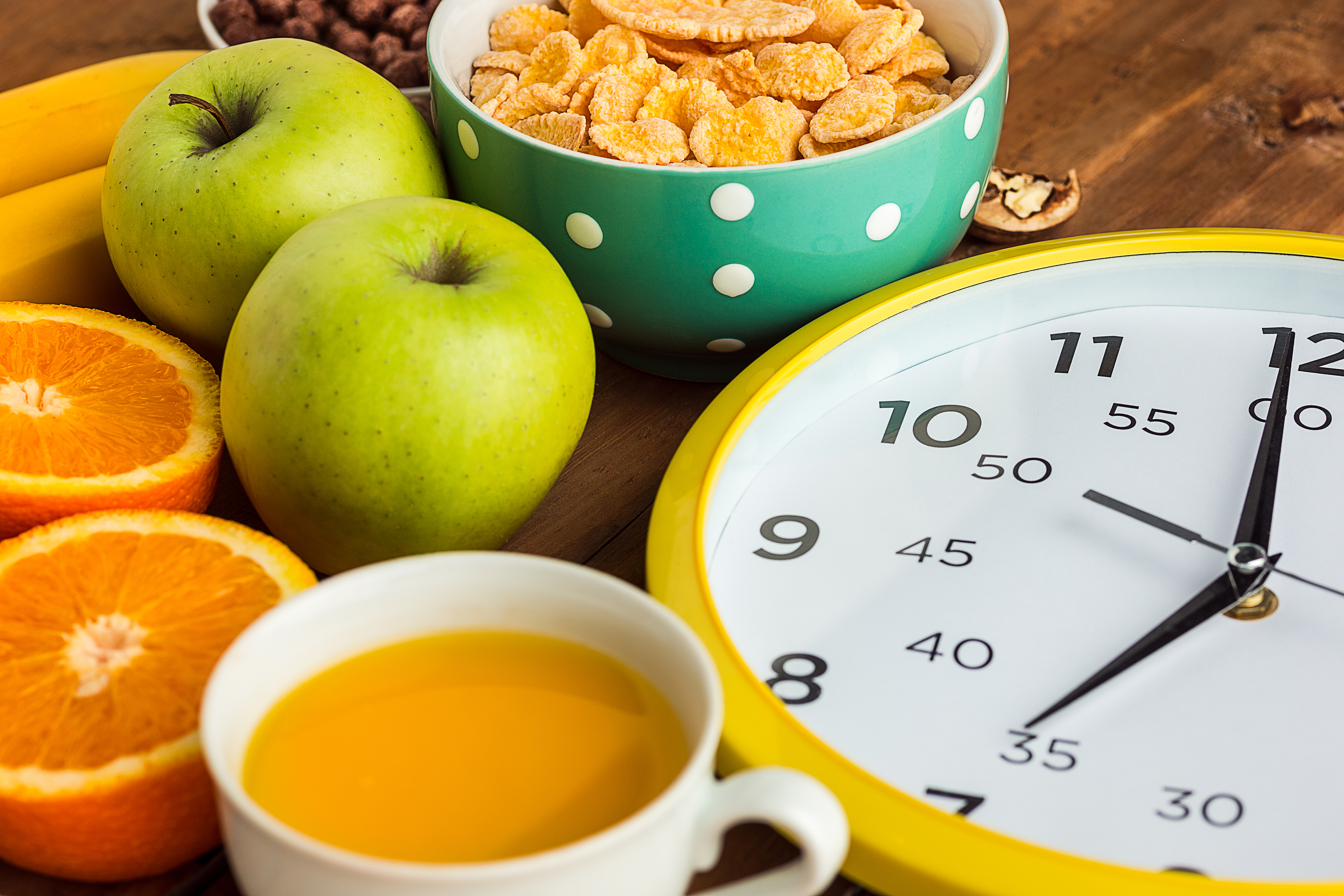 Healthy home made breakfast of muesli, apples, fresh fruits, walnuts. Served with fresh, sliced oranges.