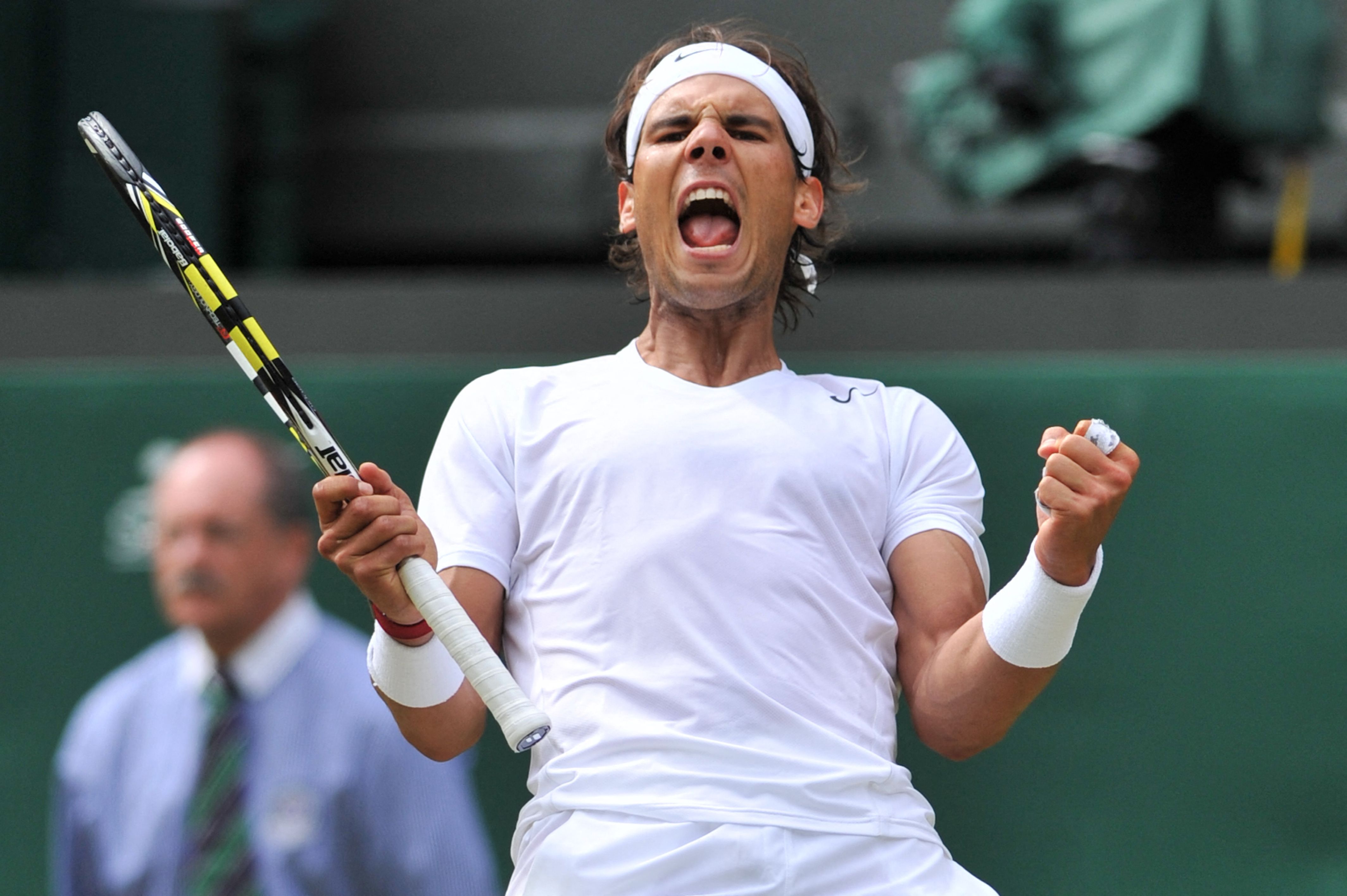 (FILES) Spain's Rafael Nadal celebrates beating Czech Republic's Lukas Rosol during their men's singles second round match on day four of the 2014 Wimbledon Championships at The All England Tennis Club in Wimbledon, southwest London, on June 26, 2014. Nadal won 4-6, 7-6, 6-4, 6-4. Rafael Nadal announced on October 10, 2024 he will retire from professional tennis after the Davis Cup finals in November, ending a career in which he won 22 Grand Slam titles and Olympic singles gold. (Photo by GLYN KIRK / AFP)