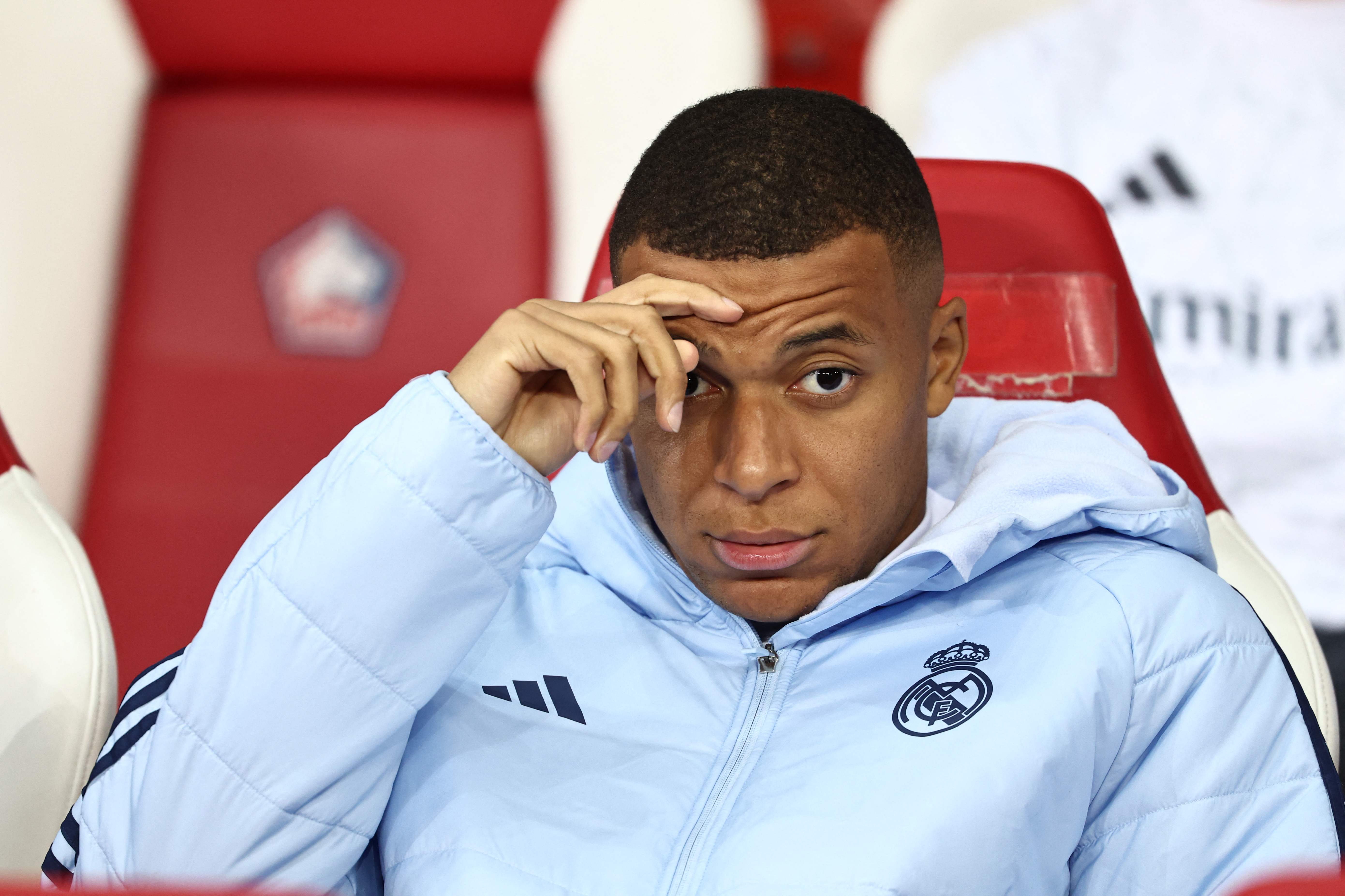 (FILES) Real Madrid's French forward #09 Kylian Mbappe looks on from the bench during the UEFA Champions League football match between Lille LOSC and Real Madrid at the Pierre Mauroy Stadium in Villeneuve-d'Ascq, northern France, on October 2, 2024. Kylian Mbappe is being investigated for rape by Swedish police, according to a newspaper report in Sweden following a visit by the Real Madrid star to Stockholm, which Mbappe denounced as "fake news". (Photo by Sameer AL-DOUMY / AFP)