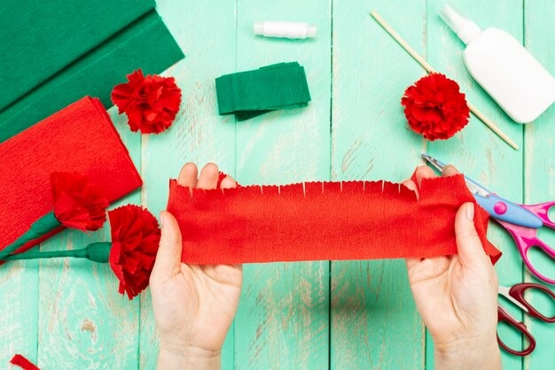 mujer elaborando flores de papel crepé