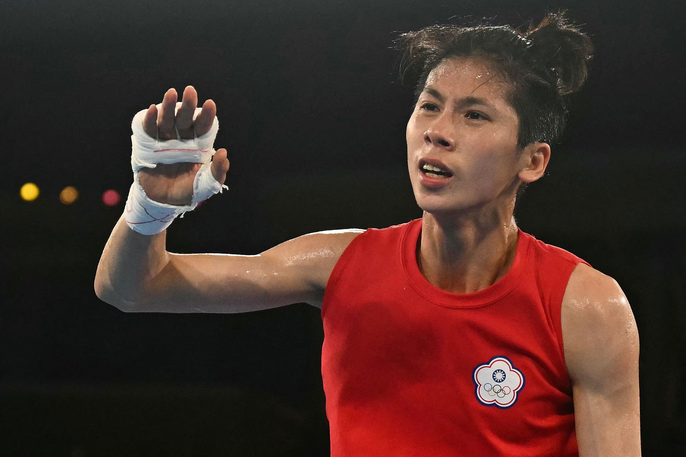 (FILES) Taiwan's Lin Yu-ting reacts after beating Poland's Julia Szeremeta (Blue) in the women's 57kg final boxing match during the Paris 2024 Olympic Games at the Roland-Garros Stadium, in Paris on August 10, 2024. Taiwan's Olympic boxing gold medallist Lin Yu-ting has pulled out of an international competition in Britain after the organiser questioned her gender eligibility, Taiwanese sports officials said on November 27. (Photo by Mauro PIMENTEL / AFP)