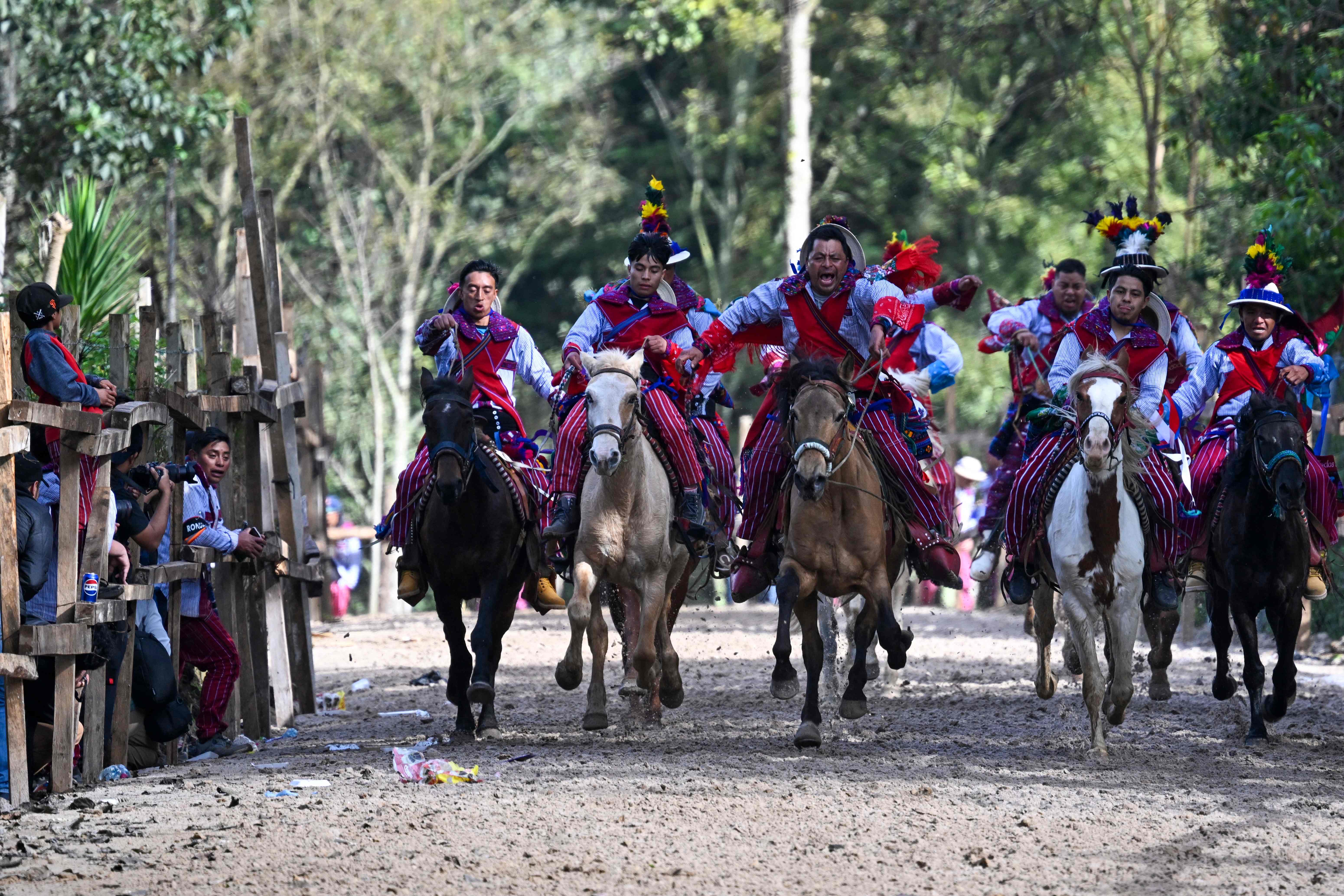 Indigenous horsemen take part in a race during All Saints Day celebrations in Todos Santos Cuchumatan, Guatemala, on November 1, 2024. (Photo by JOHAN ORDONEZ / AFP)