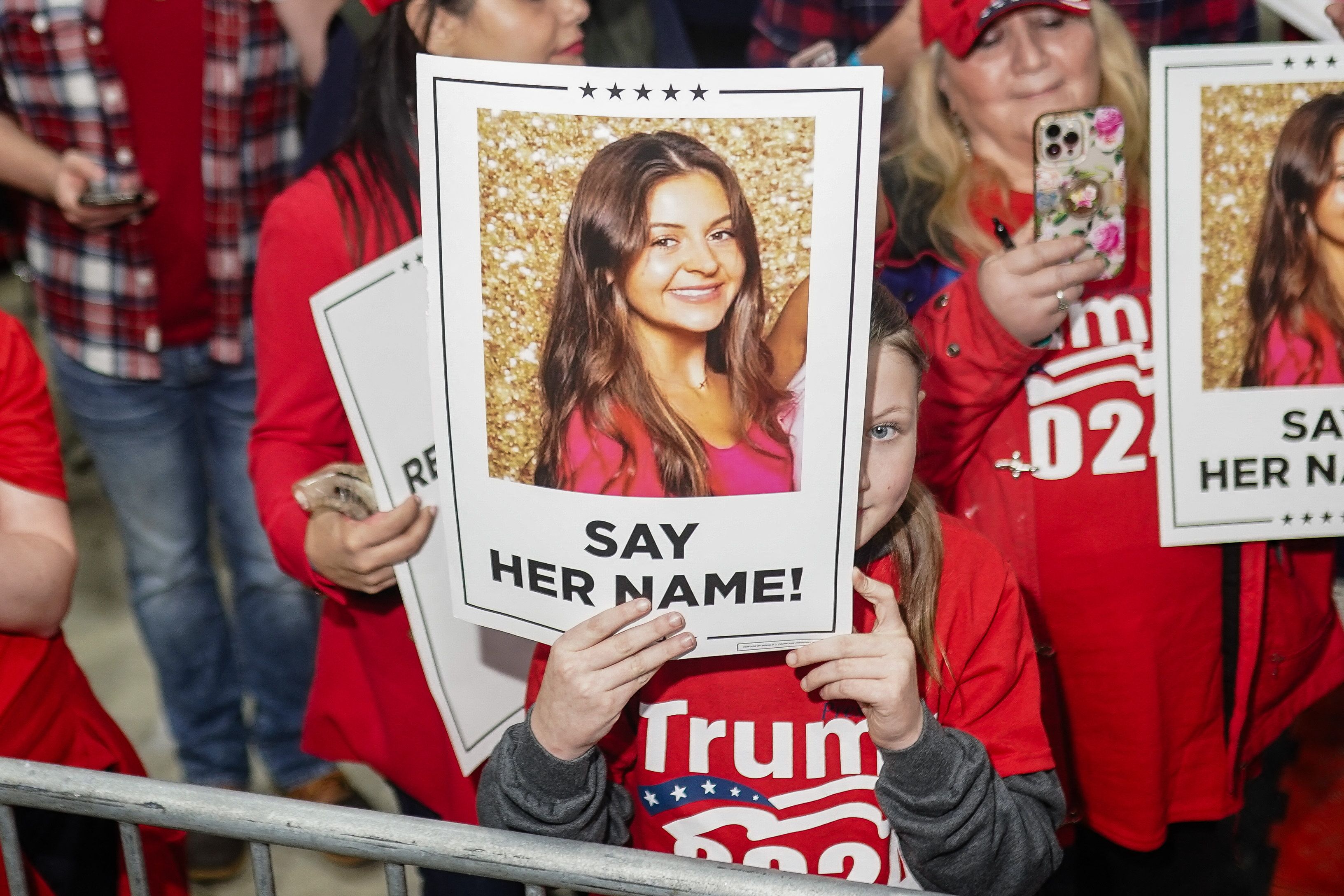 Supporters of former US President and 2024 presidential hopeful Donald Trump hold images of Laken Riley before he speaks at a "Get Out the Vote" rally in Rome, Georgia, on March 9, 2024. Riley, a nursing student, has become the face of immigration reform after her murder allegedly by an illegal immigrant on February 22, 2024. (Photo by Elijah Nouvelage / AFP)