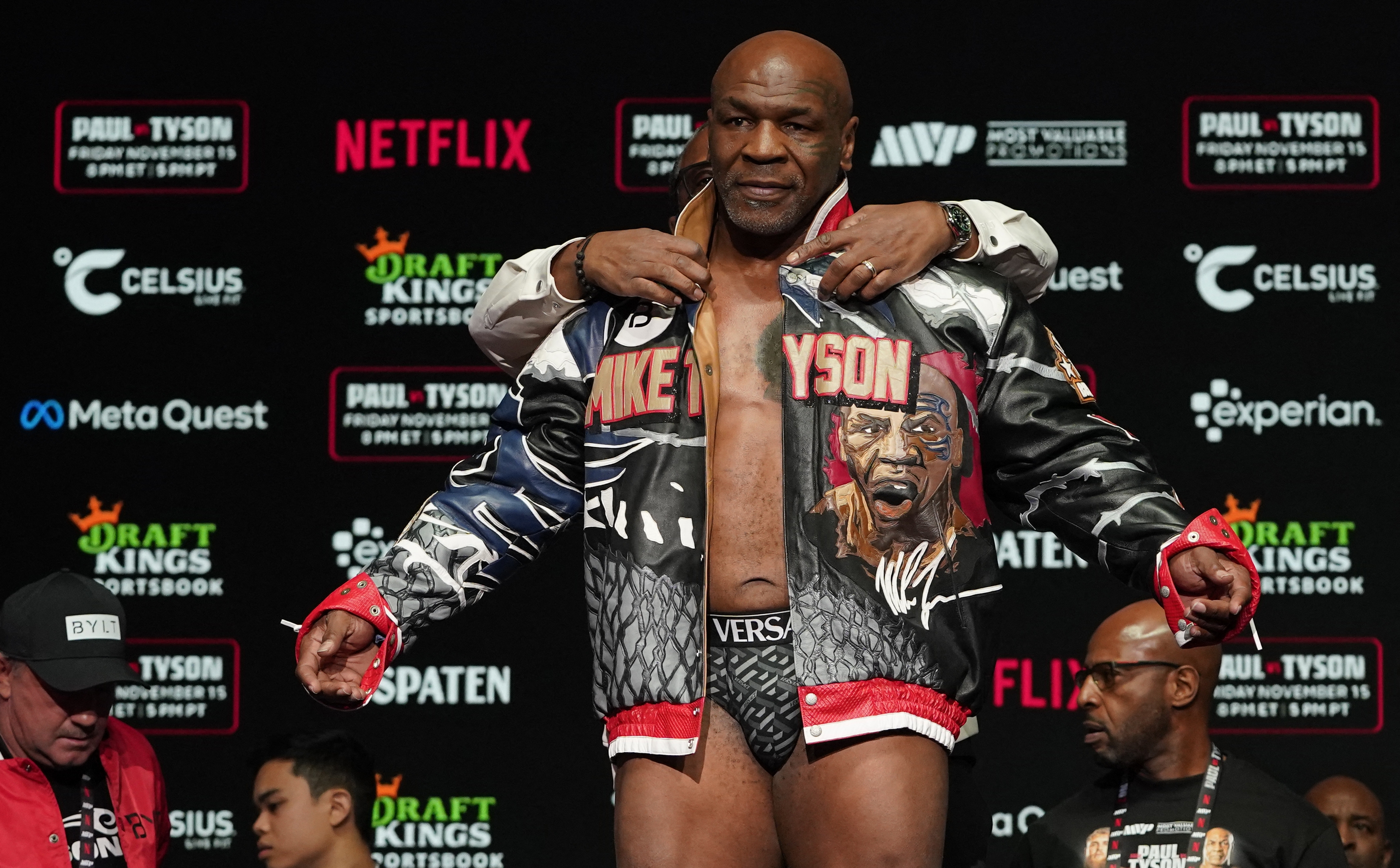 Former US heavyweight boxing champion Mike Tyson is assisted in removing his jacket during his weigh-in ahead of his heavyweight boxing match against US boxer and actor Jake Paul in Irving, Texas, on November 14, 2024. (Photo by TIMOTHY A. CLARY / AFP)