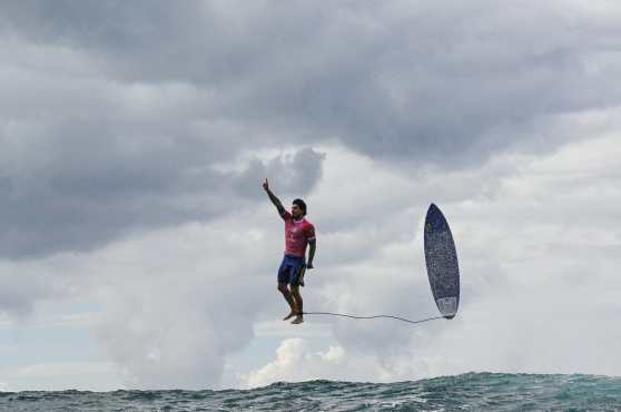 -- AFP PICTURES OF THE YEAR 2024 --

Brazil's Gabriel Medina reacts after catching a large wave in the 5th heat of the men's surfing round 3, during the Paris 2024 Olympic Games, in Teahupo'o, on the French Polynesian Island of Tahiti, on July 29, 2024.  (Photo by Jerome BROUILLET / AFP) / NO USE AFTER JANUARY 31, 2025 23:00:00 GMT - AFP PICTURES OF THE YEAR 2024