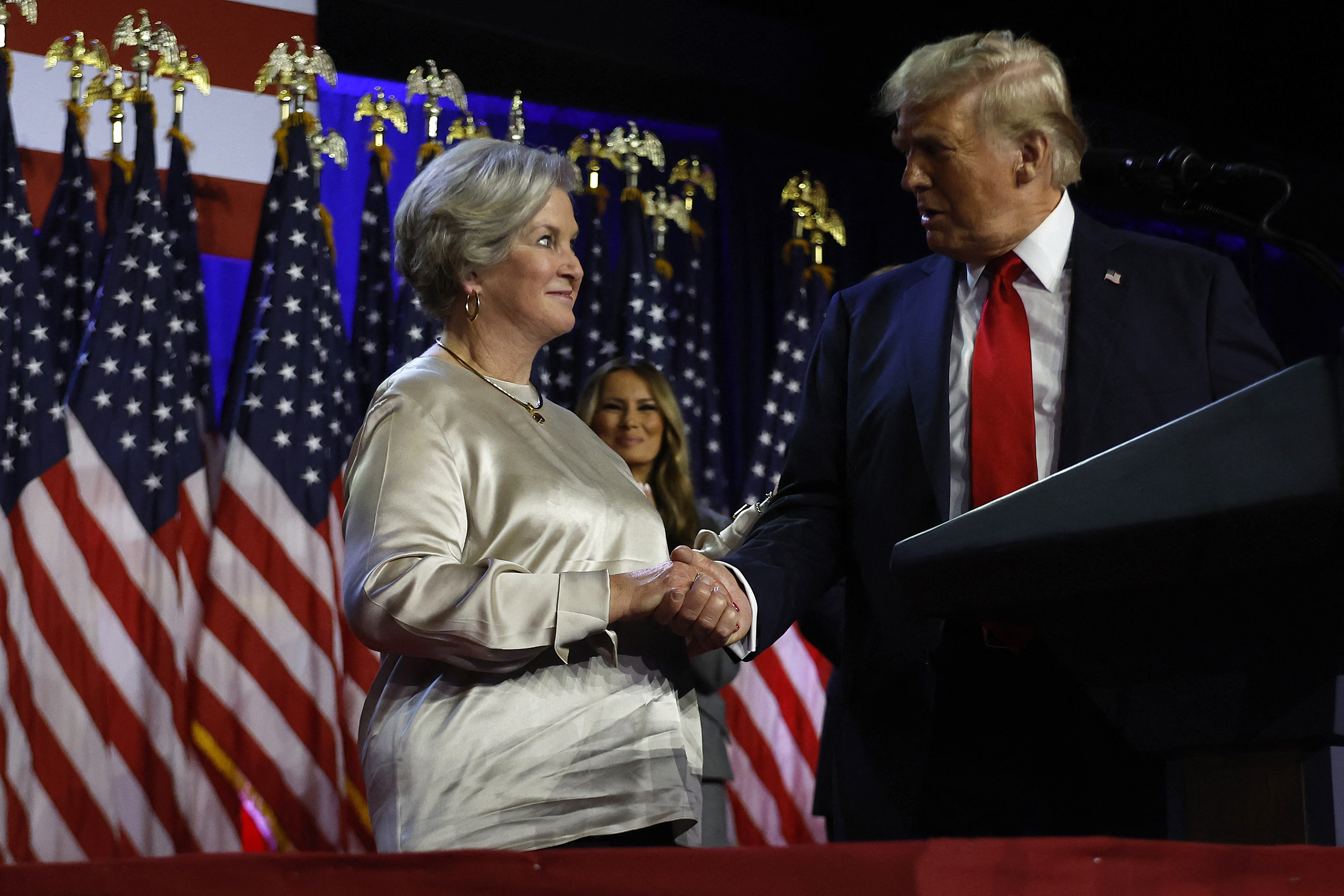 (FILES) Republican presidential nominee, former U.S. President Donald Trump praises his campaign senior advisor Susie Wiles during an election night event at the Palm Beach Convention Center on November 6, 2024 in West Palm Beach, Florida. - US President-elect Donald Trump named his campaign manager, Susie Wiles, as White House chief of staff on November 7, 2024, his first major appointment since winning this week's election. (Photo by CHIP SOMODEVILLA / GETTY IMAGES NORTH AMERICA / AFP)