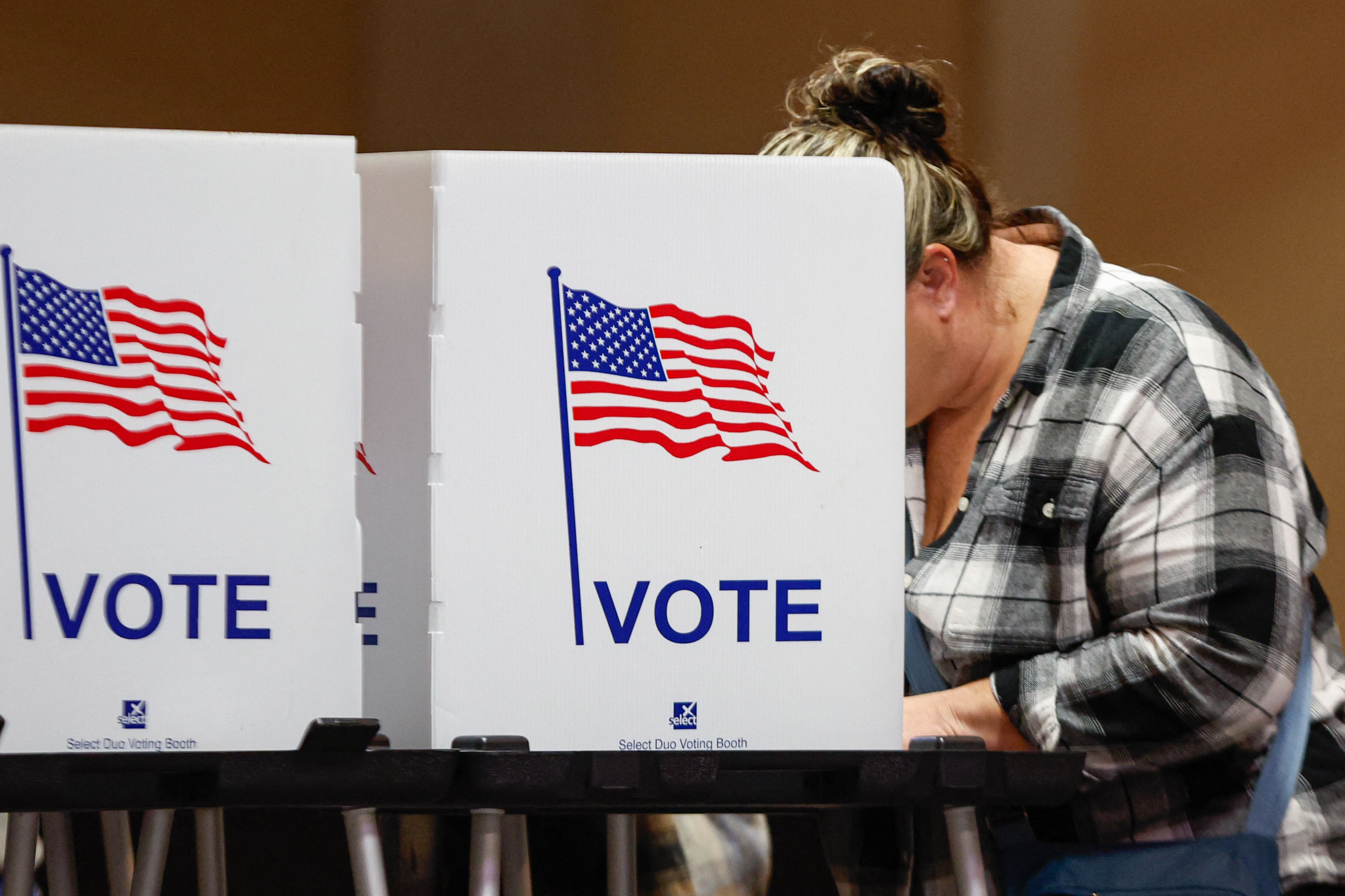 A woman votes at a polling location at The Chapel, an Evangelical church in St. Joseph, Michigan, on Election Day, November 5, 2024. (Photo by KAMIL KRZACZYNSKI / AFP)