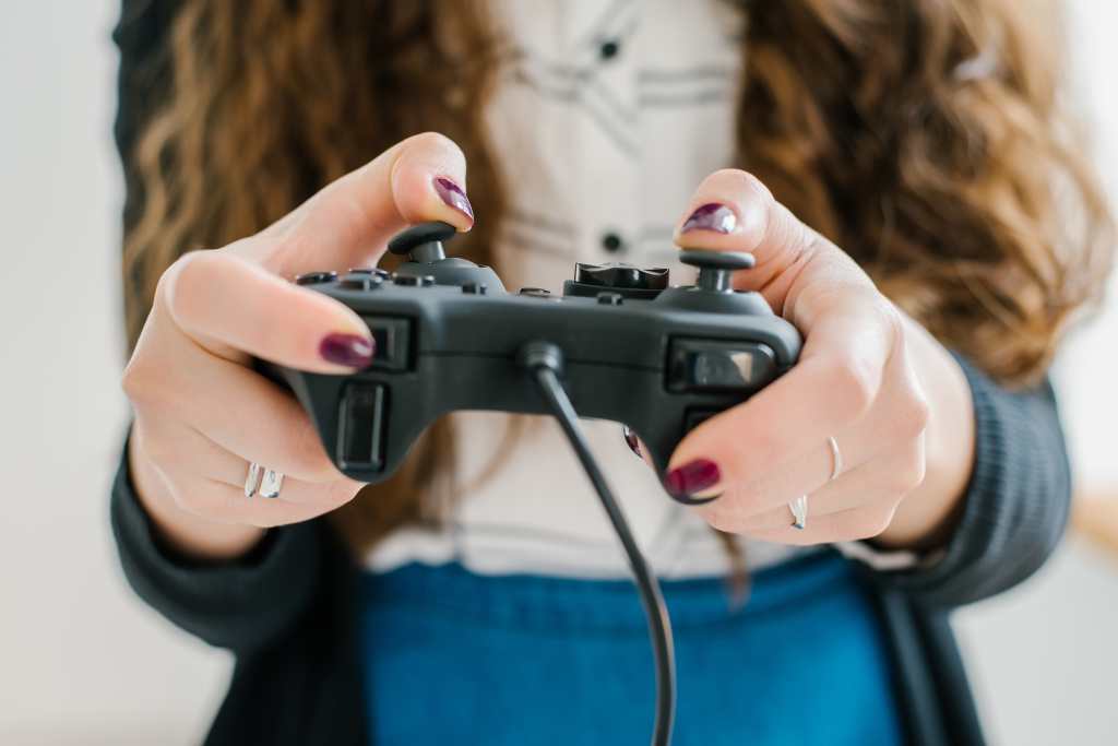 Joven utilizando la palanca de mando (joystick) de un videojuego en su casa. Foto de File404-Shutterstock, facilitada por Journalistic.