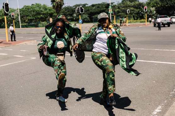 Supporters of the Umkhonto We Sizwe (MKP) party dressed with party colors sing and chant as they gather for the first anniversary of the party at the Moses Mabhida stadium  in Durban on December 15, 2024. (Photo by RAJESH JANTILAL / AFP)