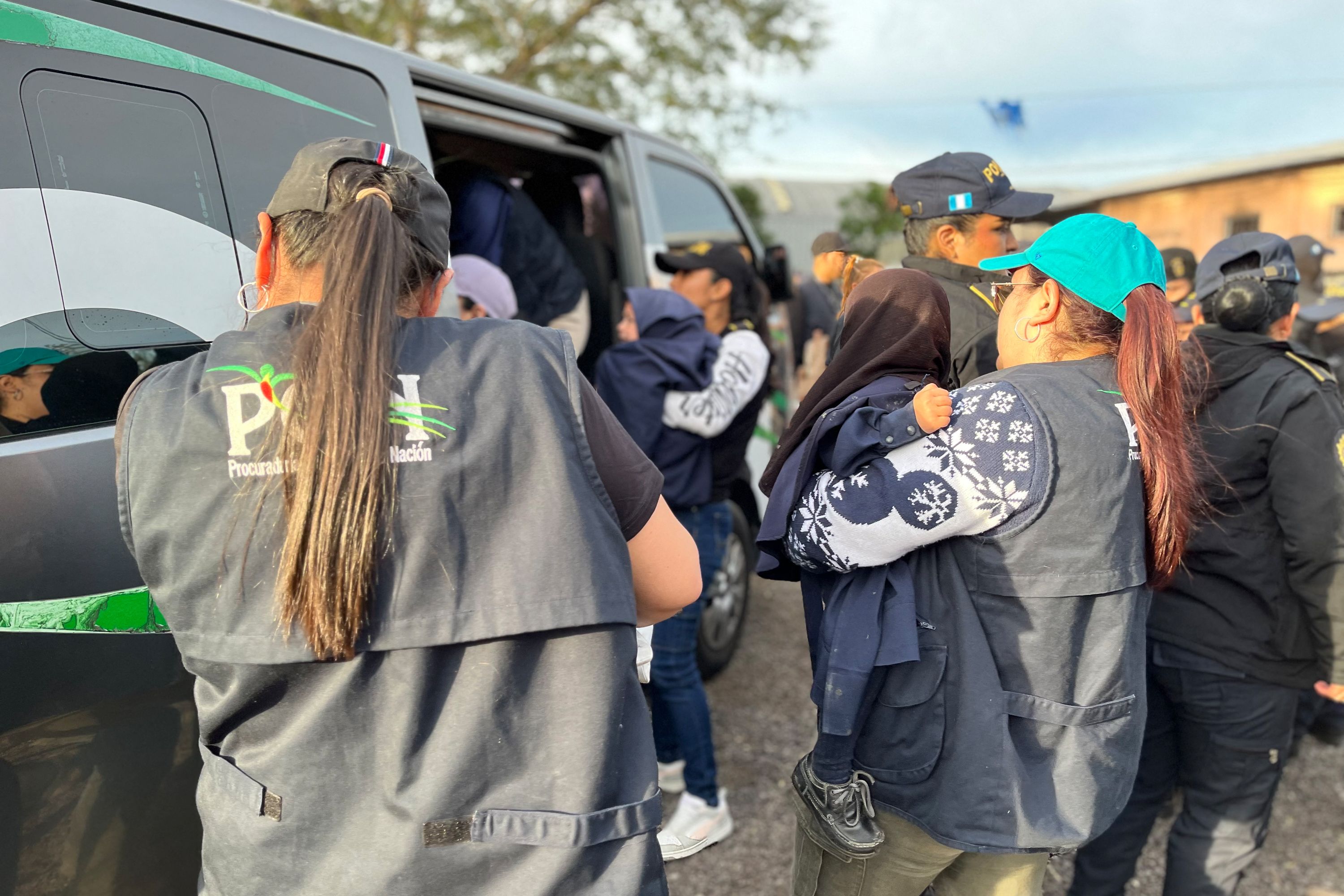 This handout picture released by the Guatemalan Attorney General of the Nation's Office (PGN) shows members of the PGN taking part in a child rescue operation at a farm in the municipality of Oratorio, Guatemala, on December 20, 2024. Guatemalan authorities on Friday rescued 160 children from a farm belonging to the Lev Tahor sect, an ultra-Orthodox Jewish group under investigation for alleged sexual abuse of minors, the Interior Minister and the Attorney General's Office announced. (Photo by Handout / Guatemalan Attorney General of the Nation's Office / AFP) / RESTRICTED TO EDITORIAL USE - MANDATORY CREDIT "AFP PHOTO / GUATEMALAN ATTORNEY GENERAL OF THE NATION'S OFFICE" - NO MARKETING NO ADVERTISING CAMPAIGNS - DISTRIBUTED AS A SERVICE TO CLIENTS