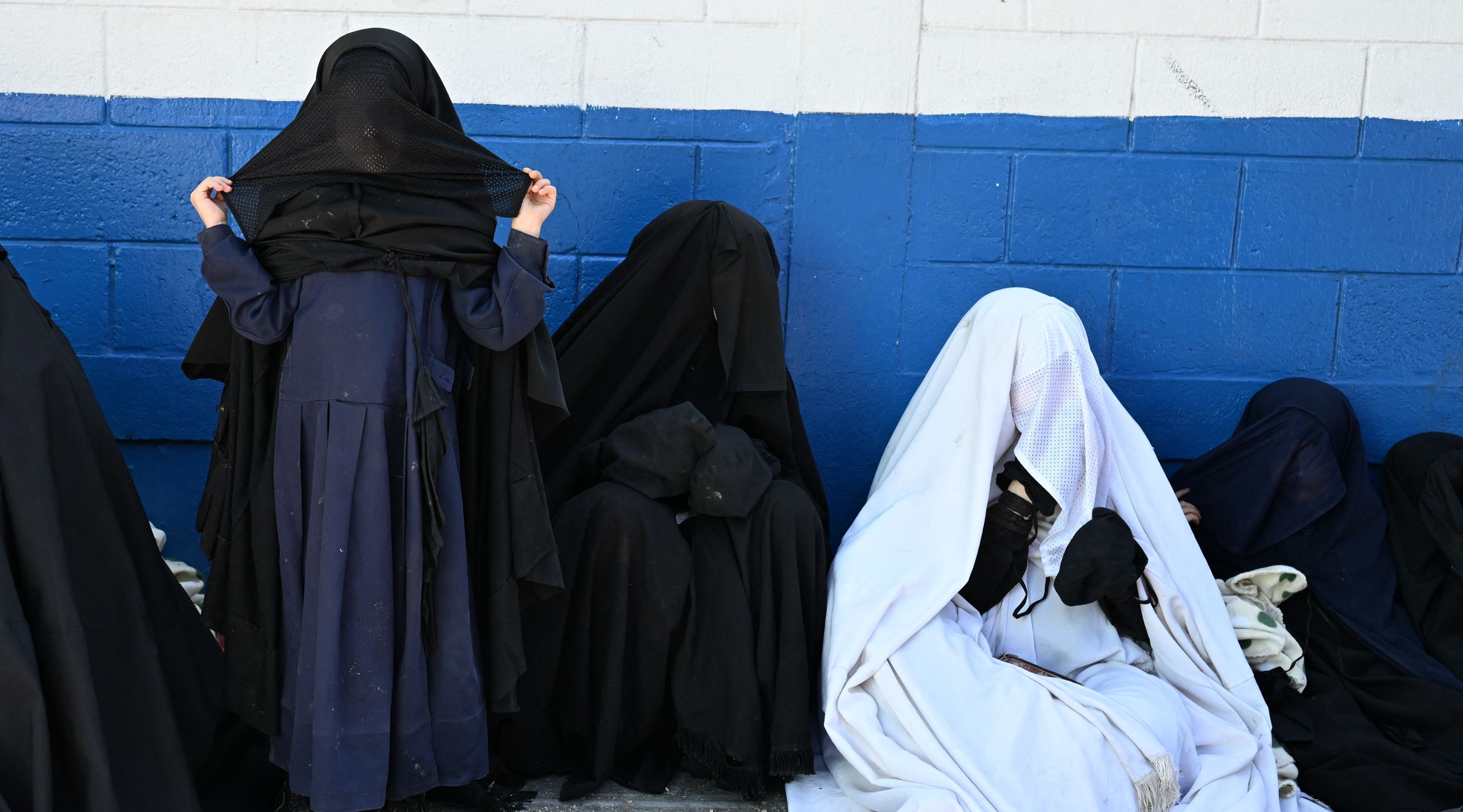 Members of the Lev Tahor Jewish community remain outside the Alida Espana de Arana special education school where the rescued children remain in Guatemala City on December 22, 2024. Guatemalan authorities on Friday rescued 160 children from a farm belonging to the Lev Tahor sect, an ultra-Orthodox Jewish group under investigation for alleged sexual abuse of minors, the Interior Minister and the Attorney General's Office announced. (Photo by Johan ORDÓÑEZ / AFP)