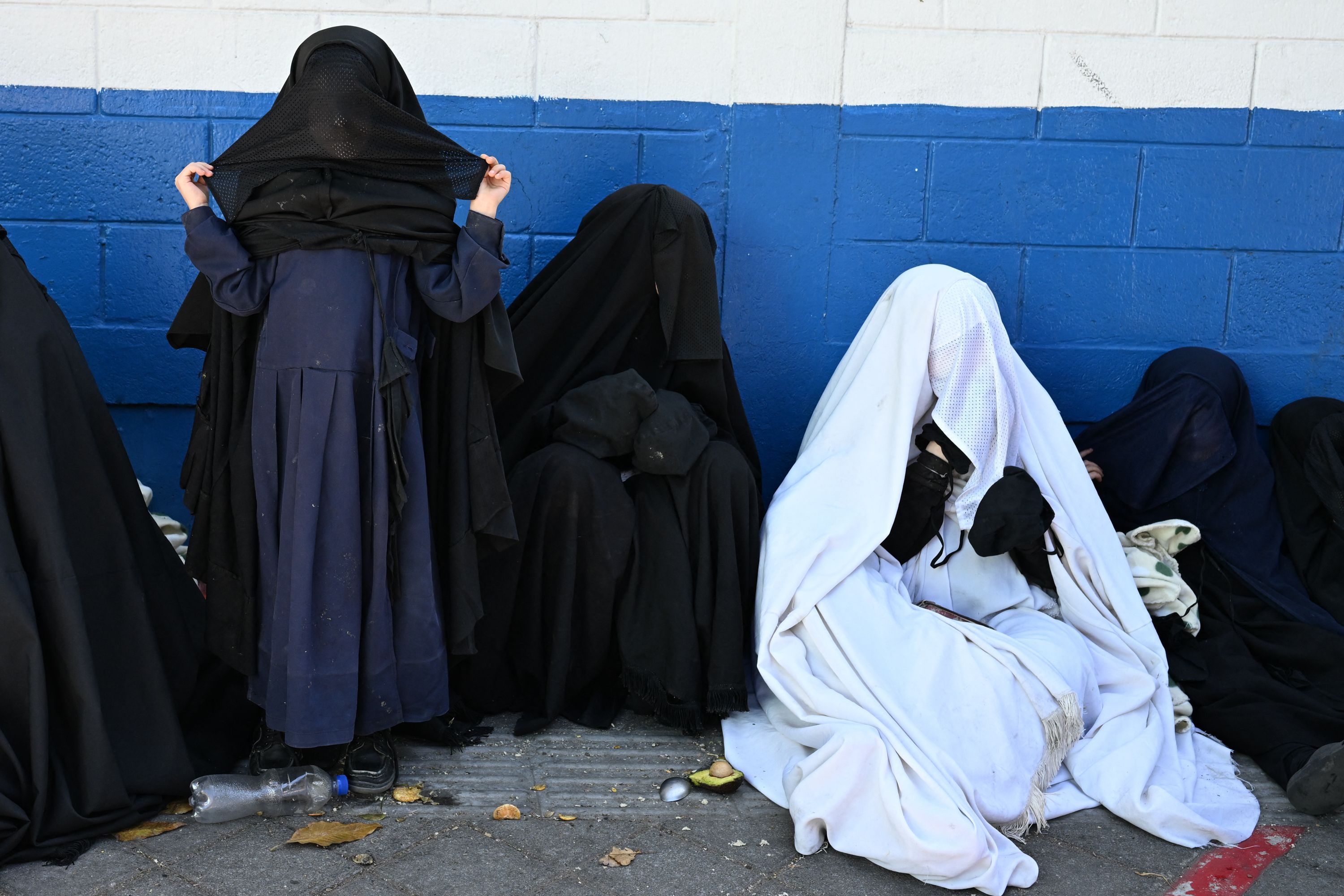 Members of the Lev Tahor Jewish community remain outside the Alida Espana de Arana special education school where the rescued children remain in Guatemala City on December 22, 2024. Guatemalan authorities on Friday rescued 160 children from a farm belonging to the Lev Tahor sect, an ultra-Orthodox Jewish group under investigation for alleged sexual abuse of minors, the Interior Minister and the Attorney General's Office announced. (Photo by Johan ORDÓÑEZ / AFP)