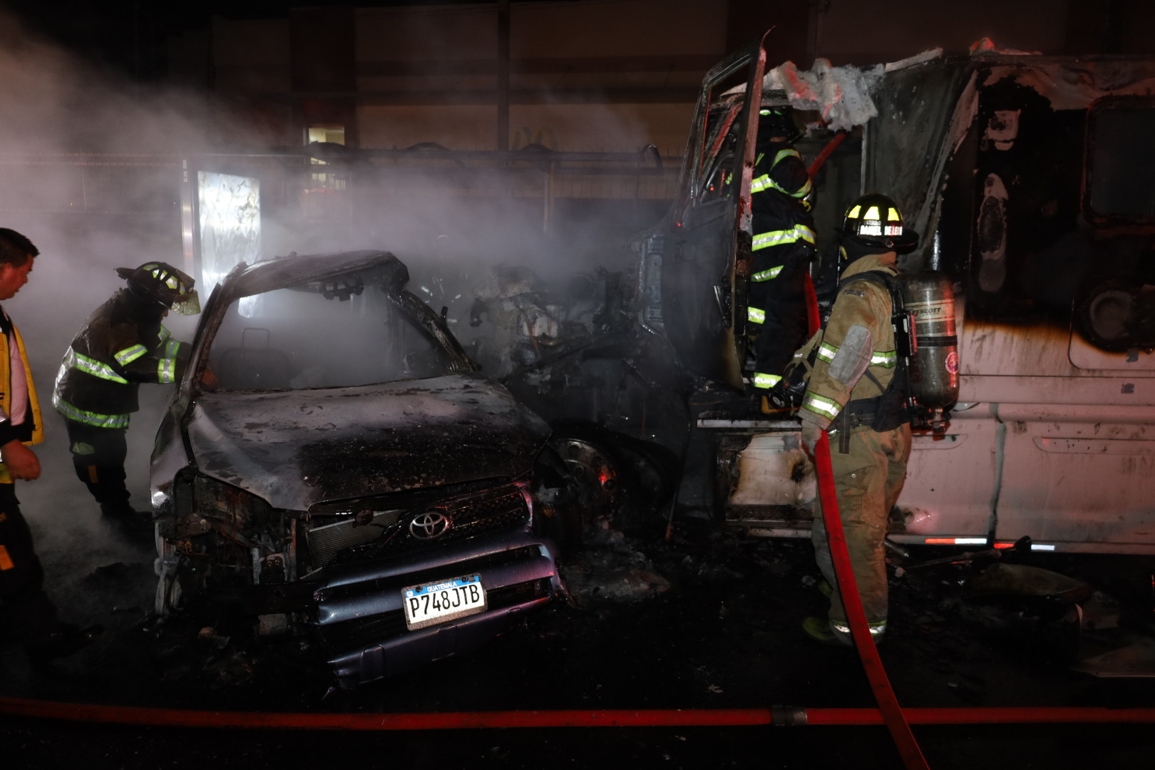 Bomberos sofocan el fuego en un vehículo que se incendió luego de chocar con un camión en ruta a El Salvador. (Foto Prensa Libre: Bomberos Voluntarios)