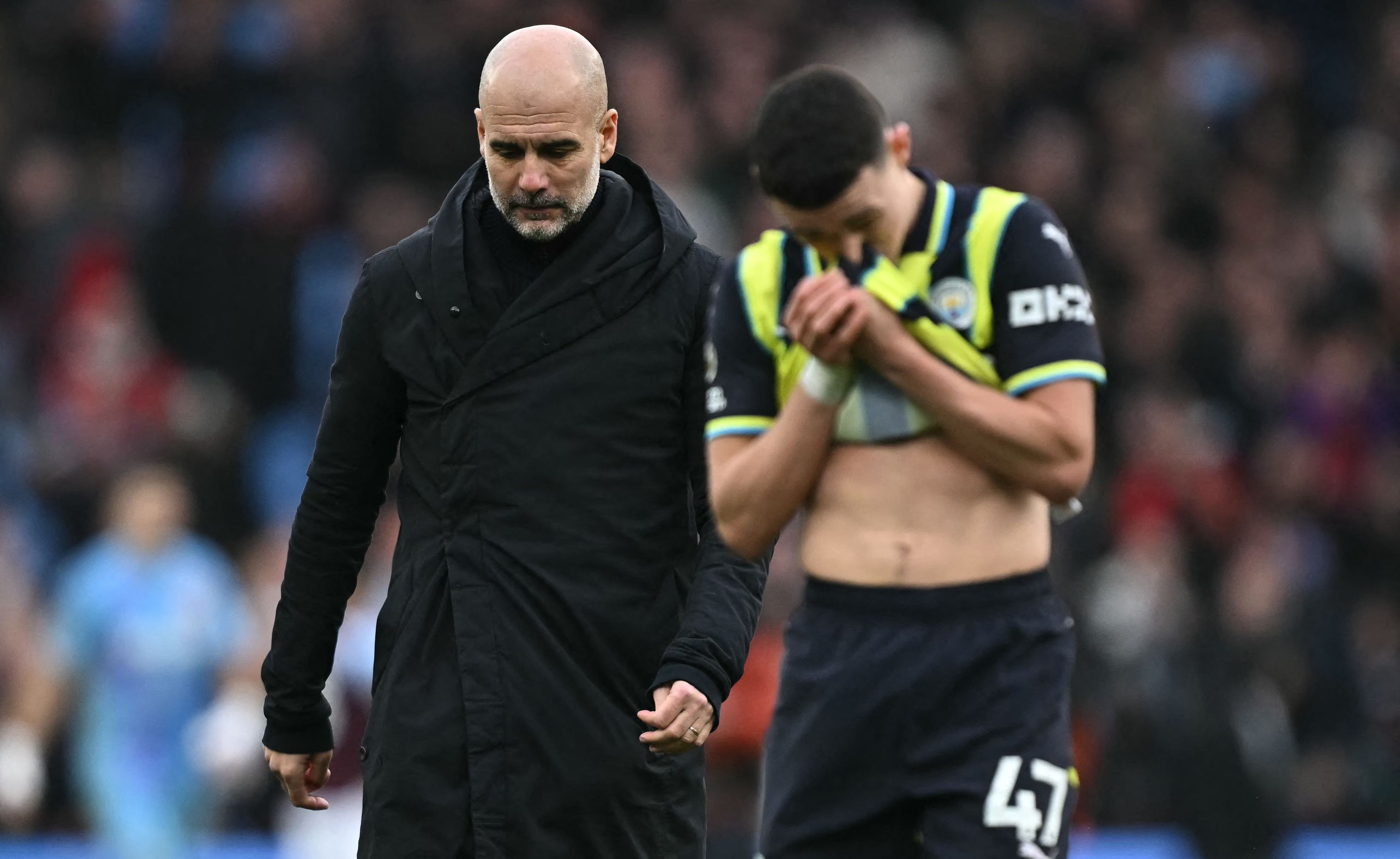 Manchester City's Spanish manager Pep Guardiola reacts to their defeat as he walks across the pitch after the English Premier League football match between Aston Villa and Manchester City at Villa Park in Birmingham, central England on December 21, 2024. Villa won the game 2-1. (Photo by Paul ELLIS / AFP) / RESTRICTED TO EDITORIAL USE. No use with unauthorized audio, video, data, fixture lists, club/league logos or 'live' services. Online in-match use limited to 120 images. An additional 40 images may be used in extra time. No video emulation. Social media in-match use limited to 120 images. An additional 40 images may be used in extra time. No use in betting publications, games or single club/league/player publications. /