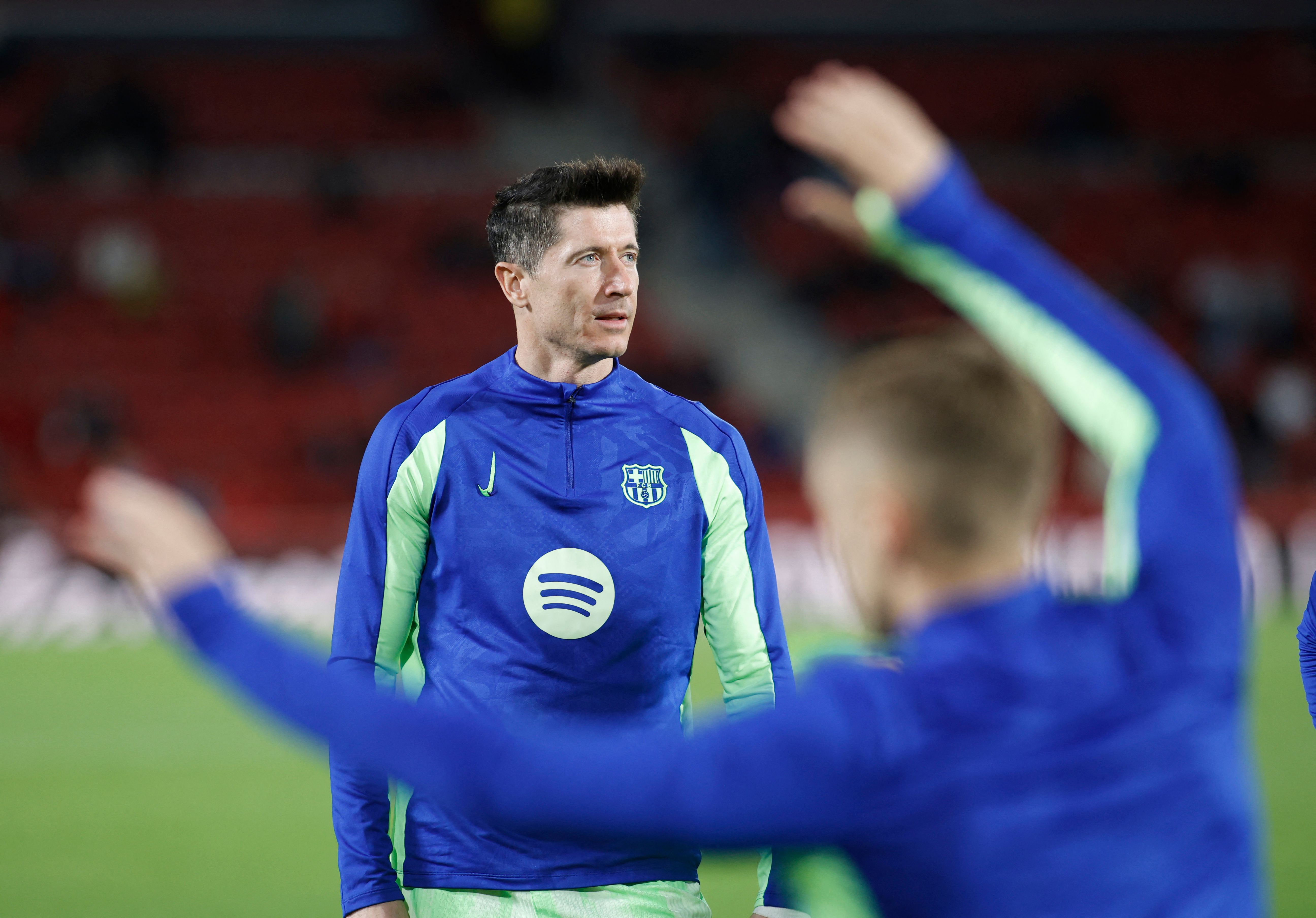 Barcelona's Polish forward #09 Robert Lewandowski warms up prior the Spanish league football match between RCD Mallorca and FC Barcelona at the Mallorca Son Moix stadium in Palma de Mallorca on December 3, 2024. (Photo by JAIME REINA / AFP)