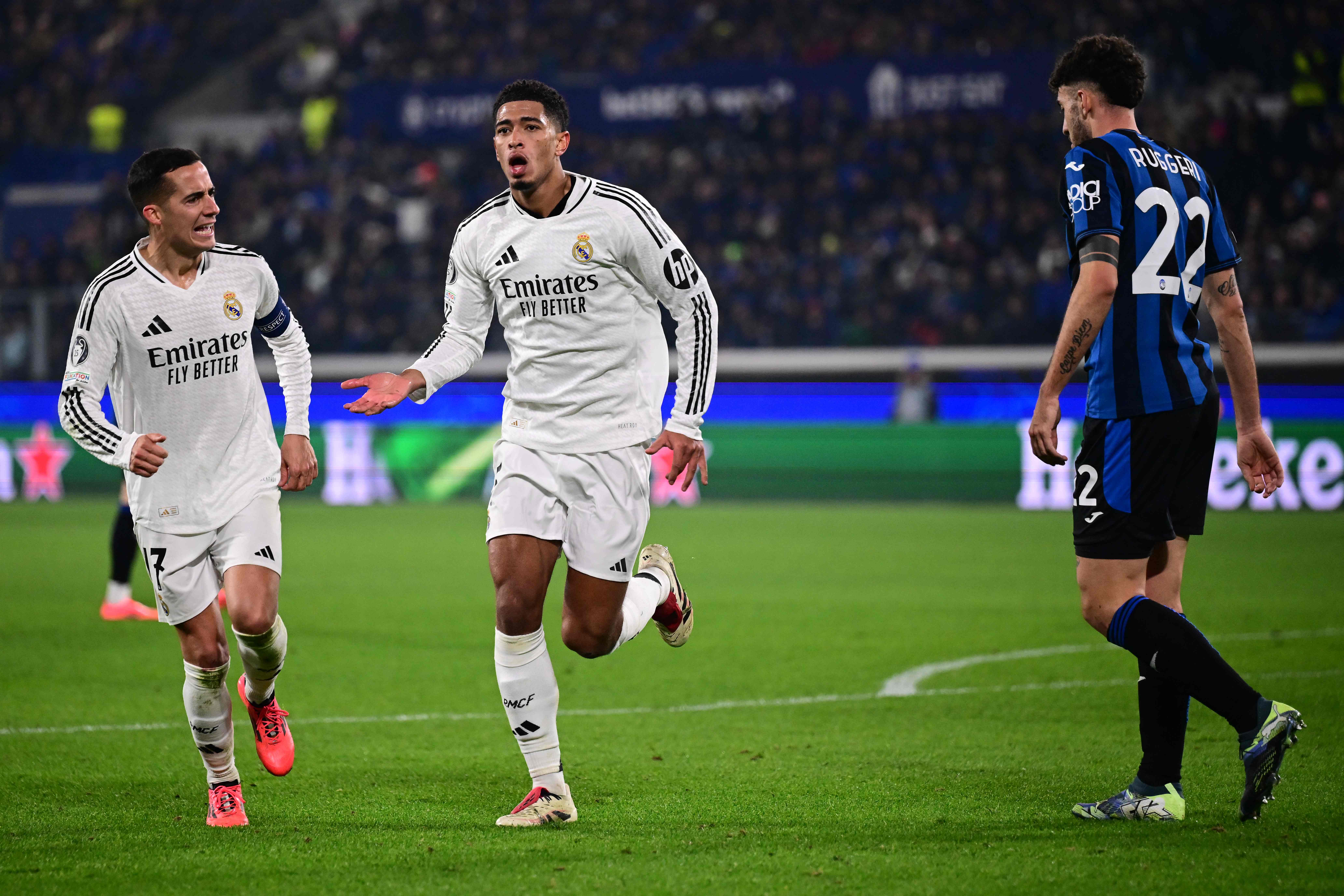 Real Madrid's English midfielder #05 Jude Bellingham celebrates with Real Madrid's Spanish defender #17 Lucas Vazquez scoring his team's third goal during the UEFA Champions League football match between Atalanta and Real Madrid at the Gewiss Stadium in Bergamo, on December 10, 2024. (Photo by Marco BERTORELLO / AFP)