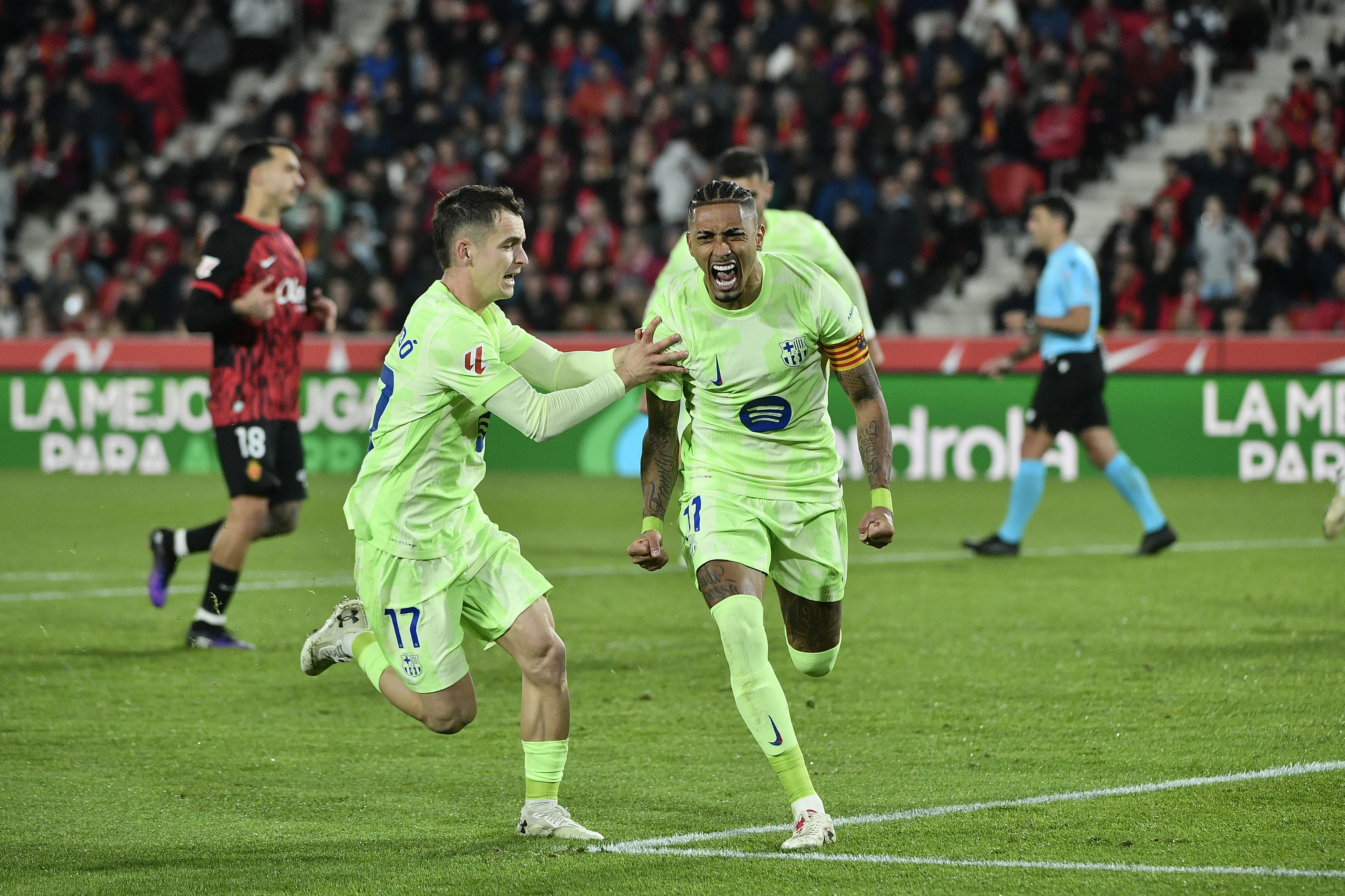 PALMA DE MALLORCA, 03/12/2024.- Los jugadores del FC Barcelona, el brasileño Raphinha (d) y Marc Casadó, celebran tras marcar el segundo gol ante el Mallorca, durante el partido de la jornada 19 de LaLiga EA Sports que RCD Mallorca y FC Barcelona disputan este martes en el estadio de Son Moix. EFE/ MIQUEL BORRÀS