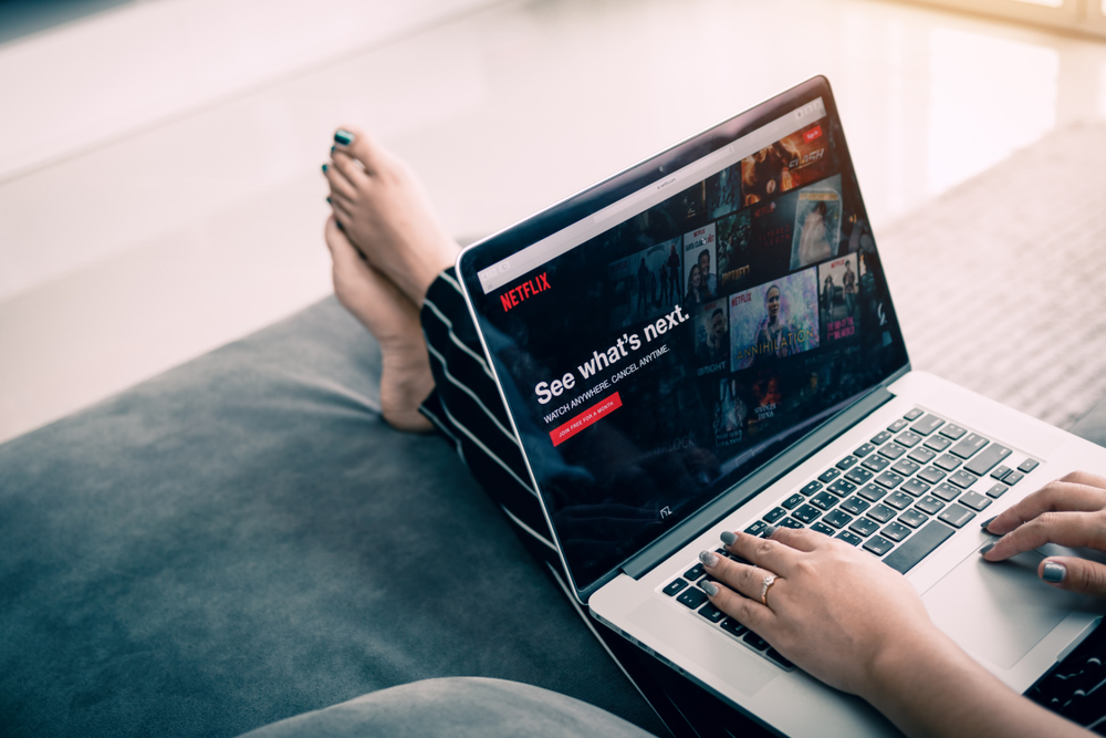 CHIANG MAI ,THAILAND - March 31, 2018 : Woman using computer laptop and watching Netflix website. Netflix being popular internationally.