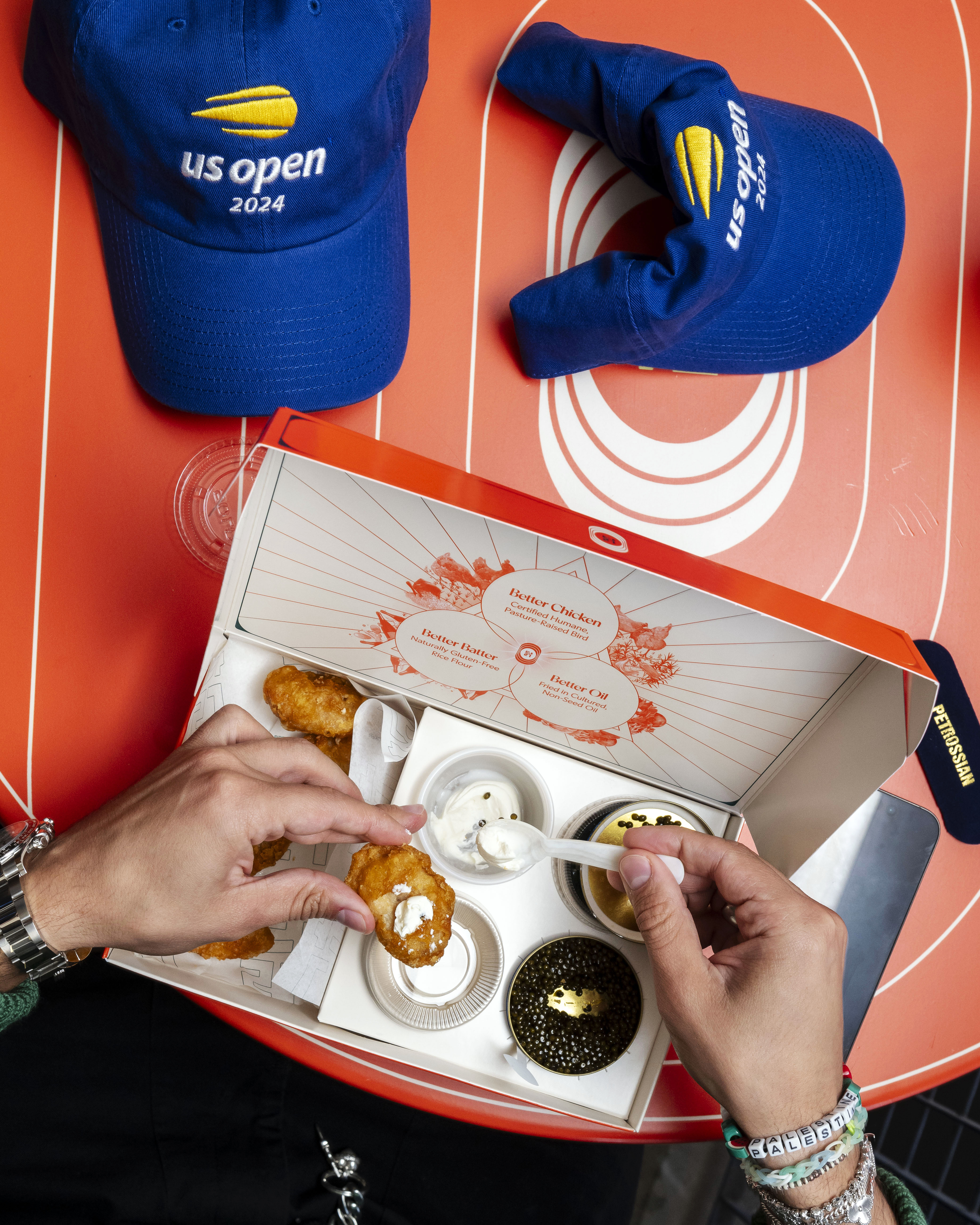 A box designed for the U.S. Open finals holds a $100 order of chicken nuggets and caviar in New York on Sept. 8, 2024. The clever design of the box is a sign that more elaborate takeout packaging is coming in 2025. (Karsten Moran/The New York Times)