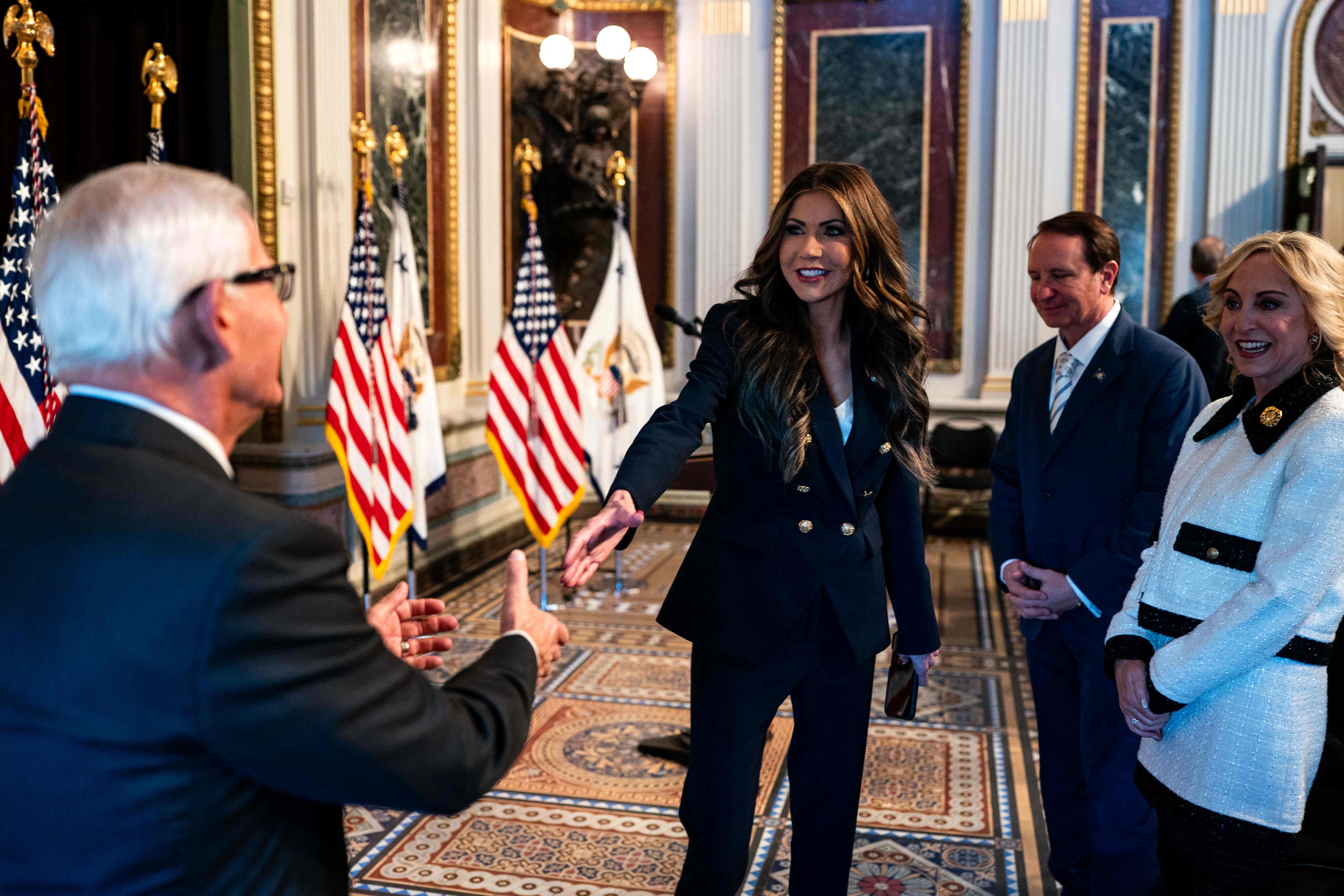 WASHINGTON, DC - JANUARY 25: Incoming Secretary of Homeland Security Kristi Noem chats with attendees ahead of her swearing in ceremony in the Indian Treaty Room of the Eisenhower Executive Office Building on January 25, 2025 in Washington, DC. The former South Dakota Governor and Trump ally will oversee immigration, counterterrorism, and FEMA, which President Trump recently suggested could be disbanded.   Kent Nishimura/Getty Images/AFP (Photo by Kent Nishimura / GETTY IMAGES NORTH AMERICA / Getty Images via AFP)