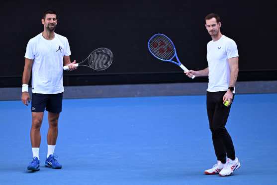 Novak Djokovic of Serbia (L) and coach Andy Murray look on during a training session ahead of the Australian Open tennis tournament in Melbourne on January 7, 2025. (Photo by William WEST / AFP) / --IMAGE RESTRICTED TO EDITORIAL USE - STRICTLY NO COMMERCIAL USE--