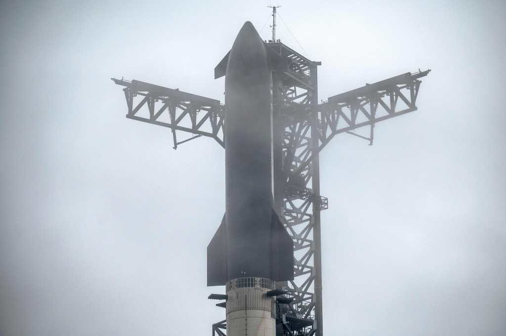 The SpaceX Starship rocket sits at the launch pad during inclement weather on January 14, 2025, near Boca Chica, Texas. The Starship Flight 7 test is scheduled to launch on January 15. (Photo by SERGIO FLORES / AFP)