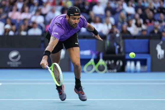 Italys Matteo Berrettini hits a return against Denmark's Holger Rune during their men's singles match on day five of the Australian Open tennis tournament in Melbourne on January 16, 2025. (Photo by Adrian Dennis / AFP) / -- IMAGE RESTRICTED TO EDITORIAL USE - STRICTLY NO COMMERCIAL USE --