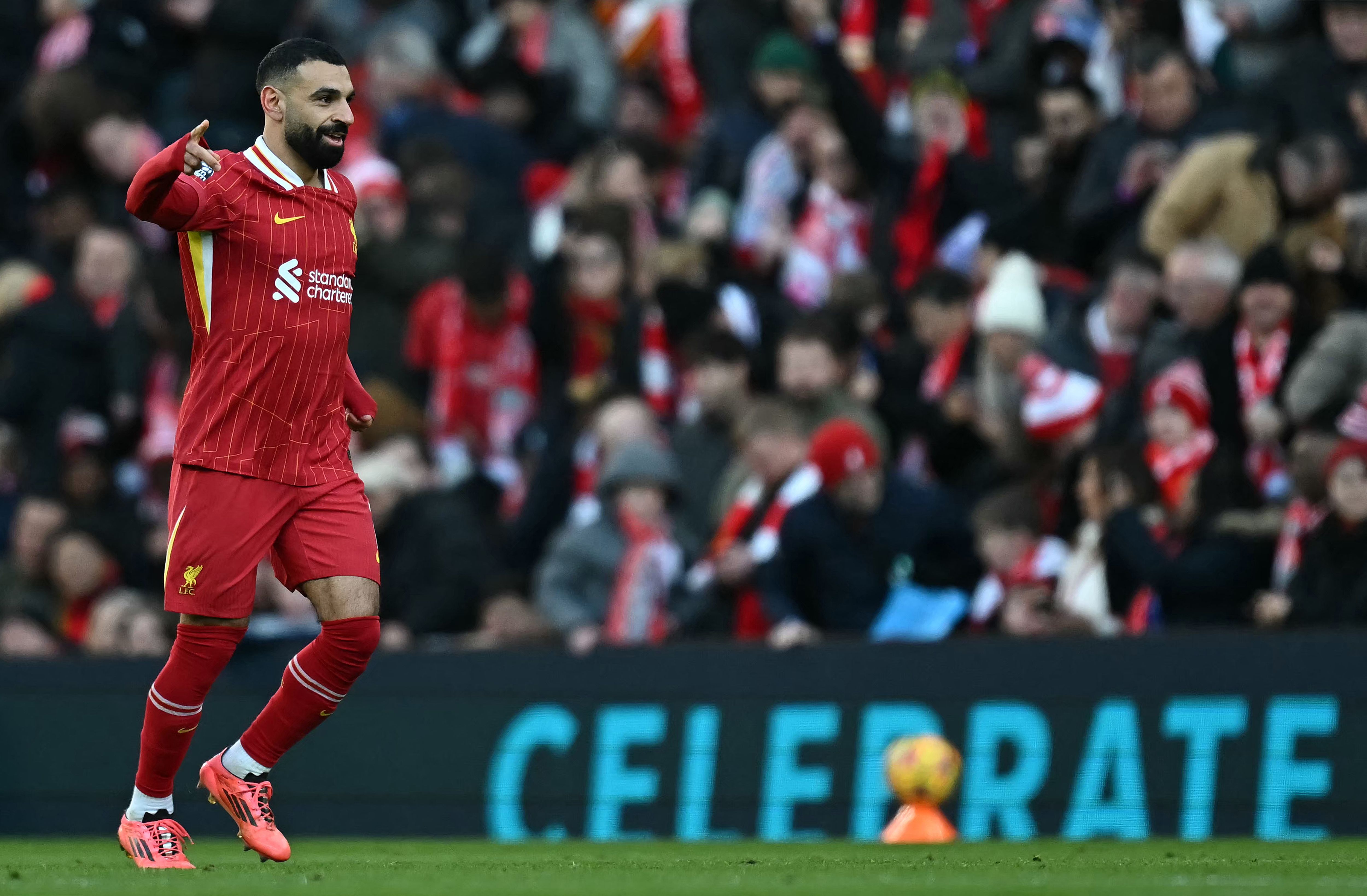 Liverpool's Egyptian striker #11 Mohamed Salah celebrates scoring the team's second goal during the English Premier League football match between Liverpool and Ipswich Town at Anfield in Liverpool, north west England on January 25, 2025. (Photo by Paul ELLIS / AFP) / RESTRICTED TO EDITORIAL USE. No use with unauthorized audio, video, data, fixture lists, club/league logos or 'live' services. Online in-match use limited to 120 images. An additional 40 images may be used in extra time. No video emulation. Social media in-match use limited to 120 images. An additional 40 images may be used in extra time. No use in betting publications, games or single club/league/player publications. /