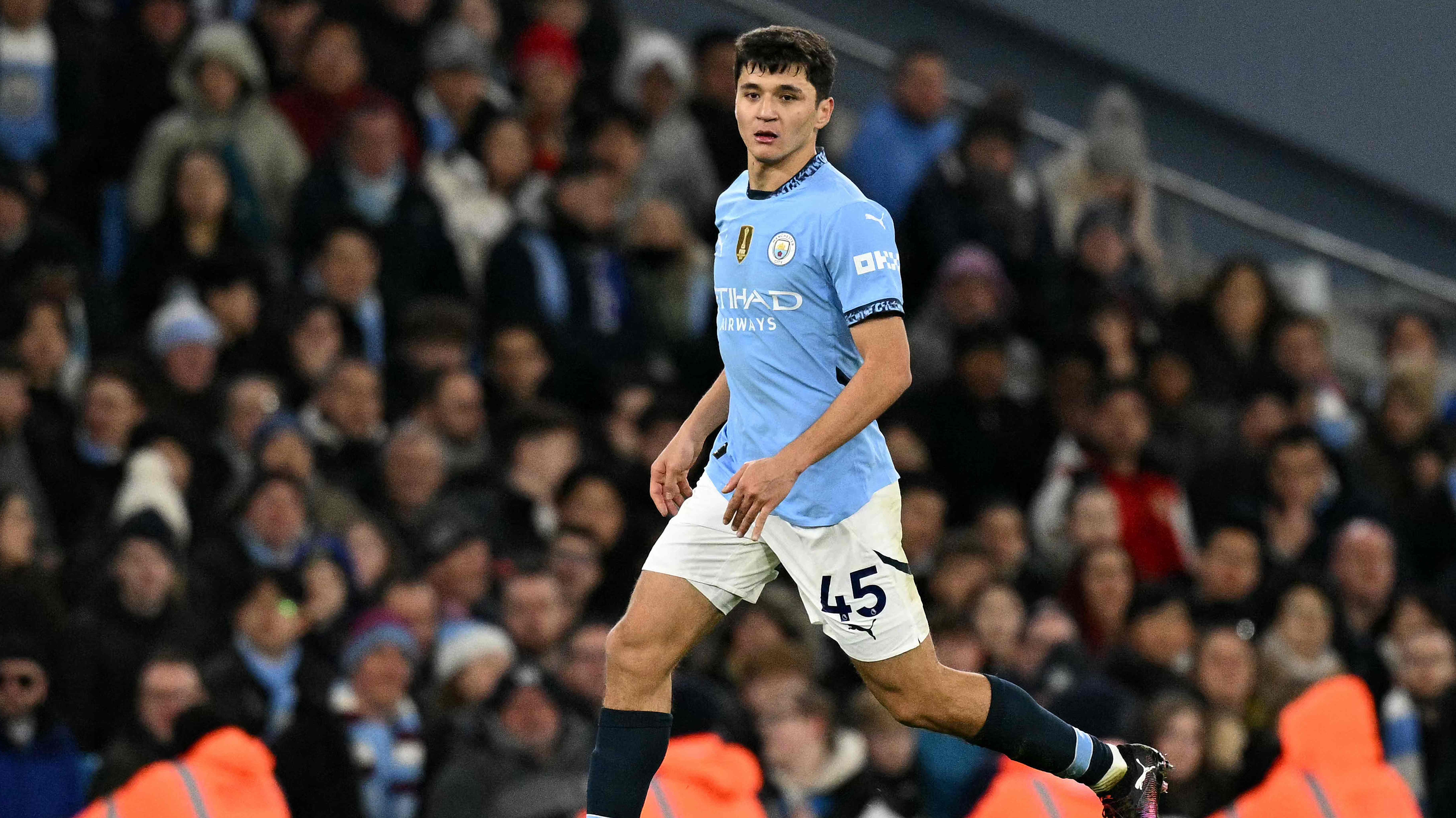 Manchester City's Uzbek defender #45 Abdukodir Khusanov runs with the ball during the English Premier League football match between Manchester City and Chelsea at the Etihad Stadium in Manchester, north west England, on January 25, 2025. (Photo by Oli SCARFF / AFP) / RESTRICTED TO EDITORIAL USE. No use with unauthorized audio, video, data, fixture lists, club/league logos or 'live' services. Online in-match use limited to 120 images. An additional 40 images may be used in extra time. No video emulation. Social media in-match use limited to 120 images. An additional 40 images may be used in extra time. No use in betting publications, games or single club/league/player publications. /