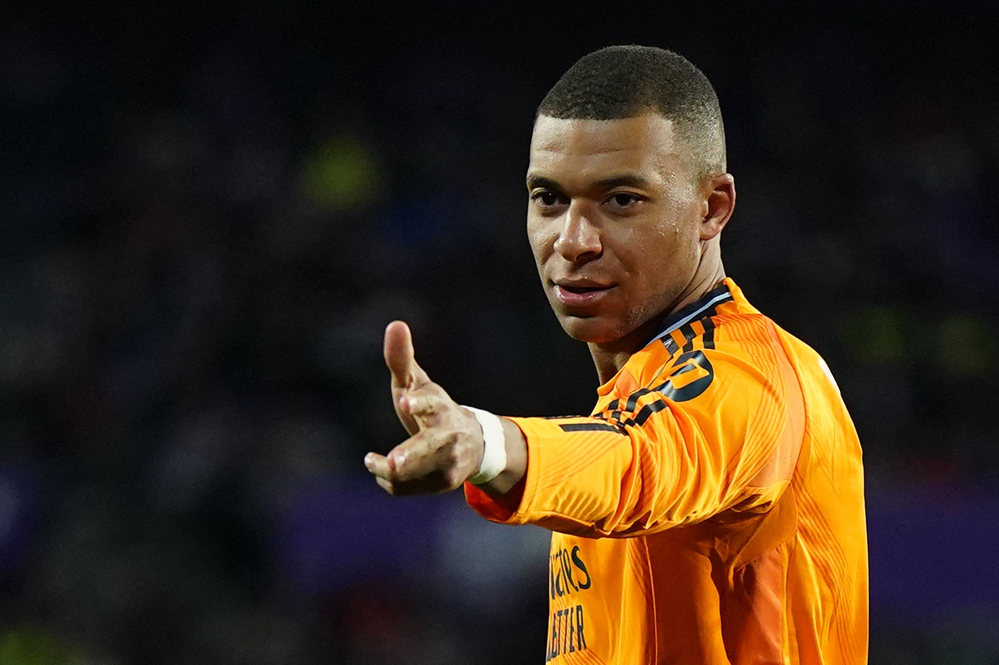 Real Madrid's French forward #09 Kylian Mbappe celebrates scoring his team's third goal during the Spanish league football match between Real Valladolid FC and Real Madrid CF at the Jose Zorrilla stadium in Valladolid on January 25, 2025. (Photo by CESAR MANSO / AFP)